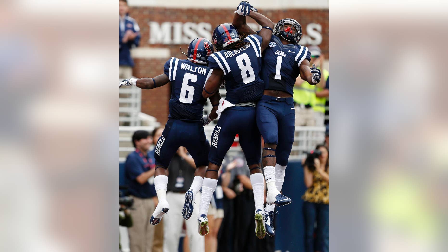Mississippi running back Jaylen Walton (6) and teammates Quincy Adeboyejo, and Laquon Treadwell (1) celebrate Walton's 71-yard touchdown run against Louisiana-Lafayette during the second half at an NCAA college football game at Vaught-Hemingway Stadium in Oxford, Miss., Saturday, Sept. 13, 2014. No. 14 Mississippi won 56-15. (AP Photo/Rogelio V. Solis)