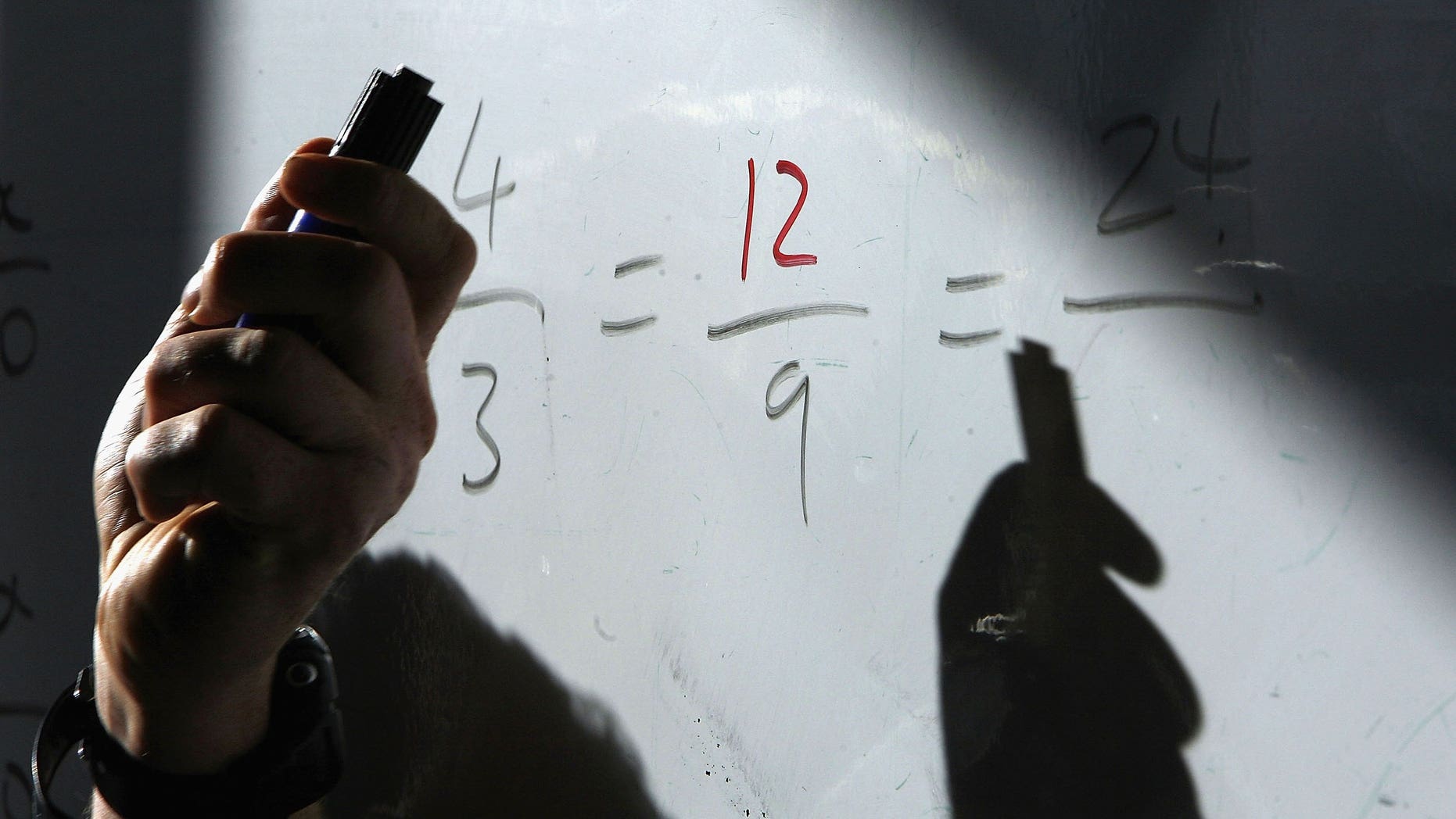 BIRMINGHAM, UNITED KINGDOM - OCTOBER 04: A maths teacher uses his white board to explain a sum to pupils King Edward VI High School for Girls on 4 October, 2006, Birmingham, England. The independent school for girls continues it's tradition to be one of the top schools in Britain having achieved a 94% pass rate at A and B grades in it's A level results. Last year, 27.1% of pupils in independent schools gained three or more grade A's at A-level, compared with 8% of pupils in all state schools. (Photo by Christopher Furlong/Getty Images)