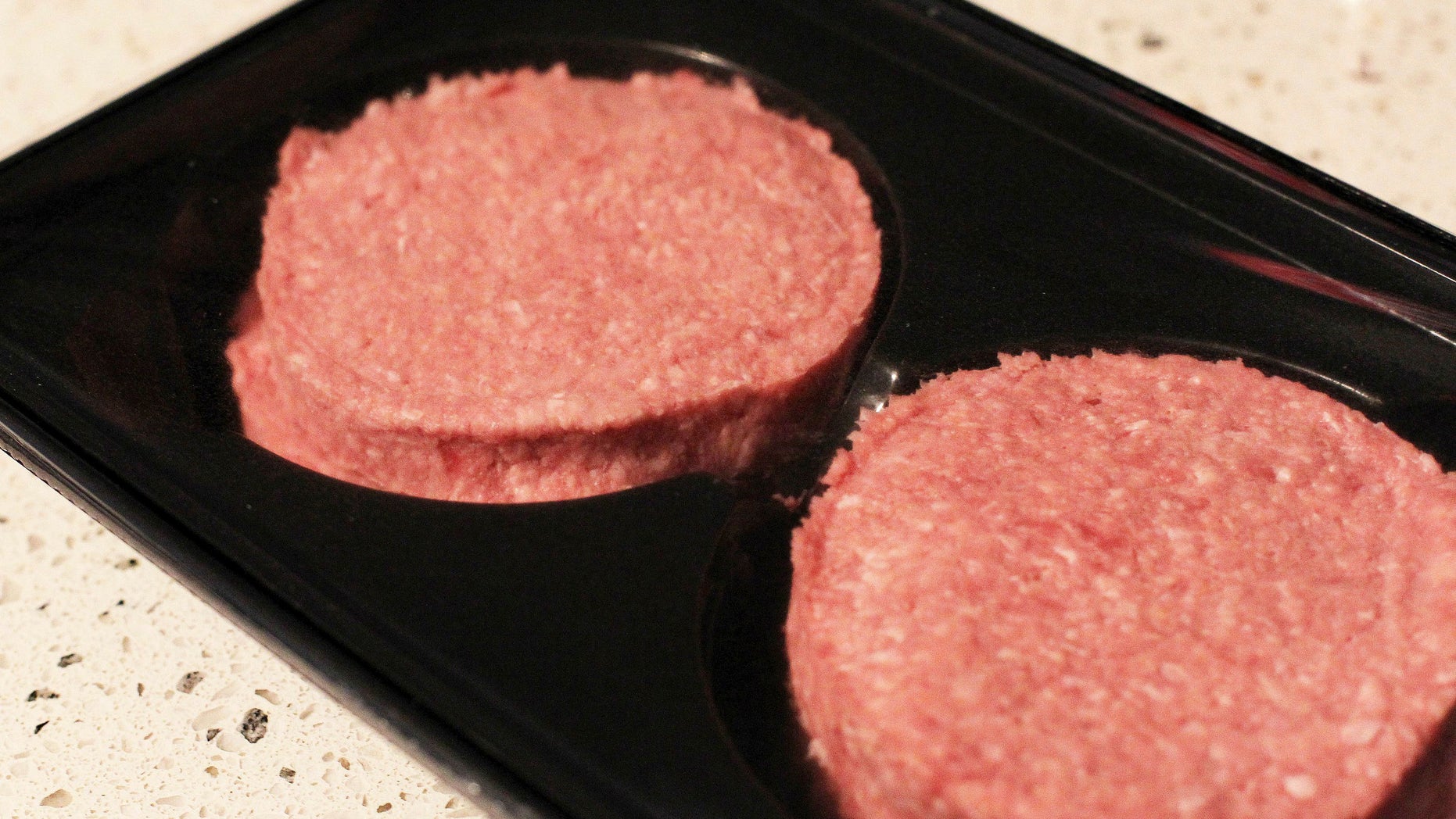 Photo made Jan 16 2013 of two beef burgers purchased in Ireland, following an outcry over the revelation that some burgers made in the republic and on sale in British supermarkets contained a large proportion of horse meat. The burgers were swiftly withdrawn from sale. A Spanish supermarket chain has withdrawn its own-brand hamburgers Wednesday Jan 30 2013 after a consumer protection group also found tiny traces of horsemeat in them. (AP Photo/Niall Carson/PA) UNITED KINGDOM OUT NO SALES NO ARCHIVE