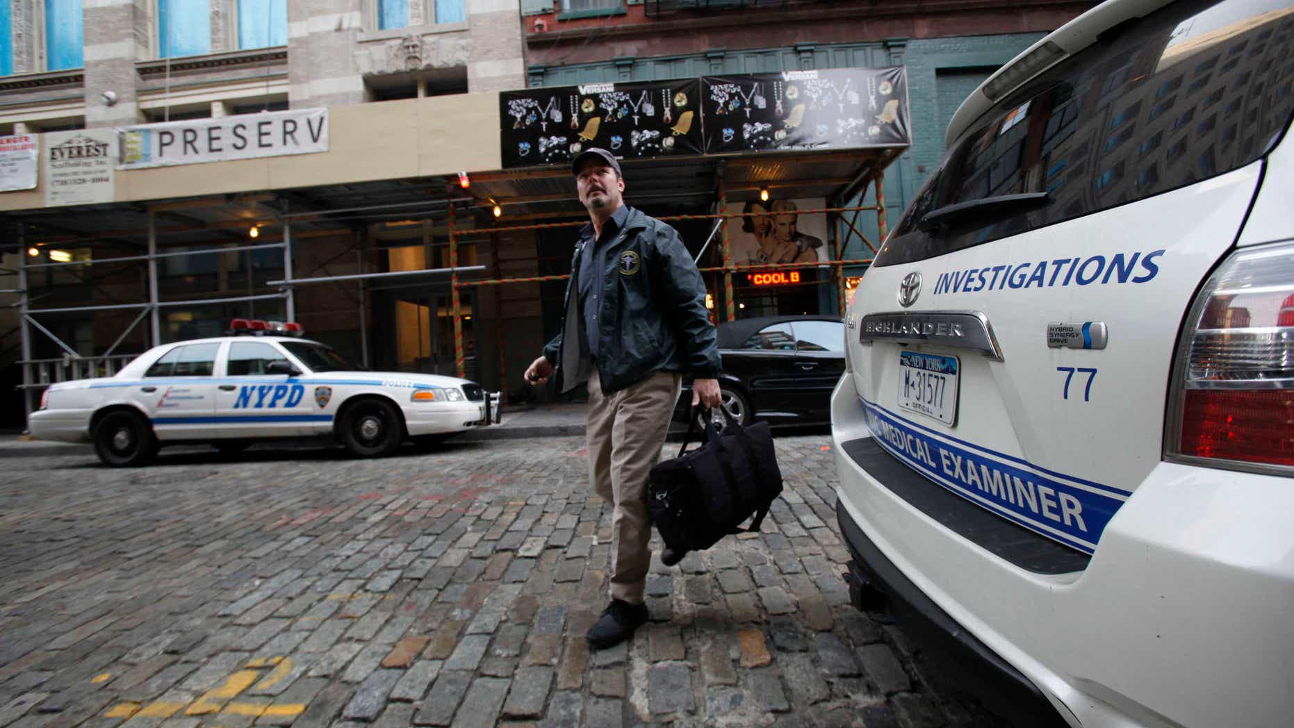 Dec. 11: A medical examiner arrives at the apartment building where Mark Madoff lived in New York. Mark, one of Bernard Madoff's sons, was found dead of an apparent suicide, according to a law enforcement official.