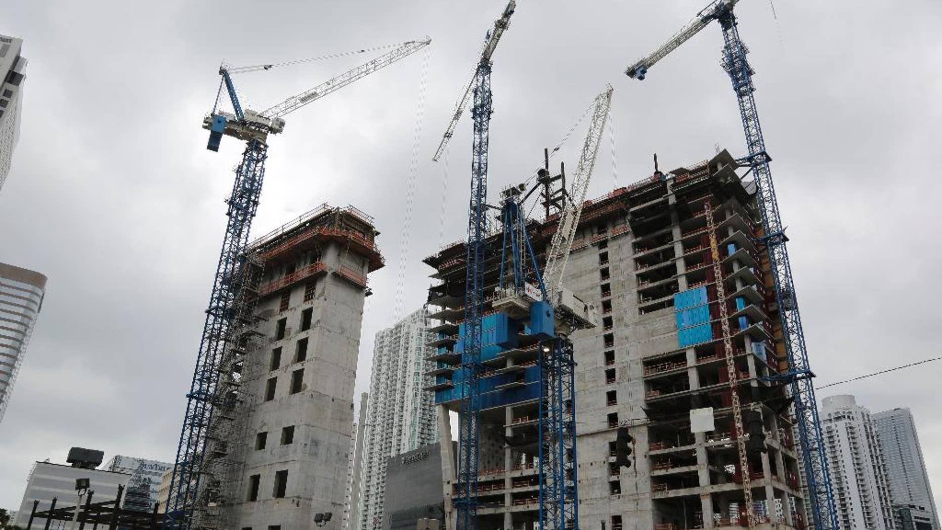 In this Friday, May 16, 2014 photo, cranes fill the skyline at the Brickell CityCentre construction site located in the center of the Brickell financial district in downtown Miami. The project is mixed use office, residential, hotel, retail and entertainment space. The Commerce Department reports on U.S. construction spending in May on Tuesday, July 1, 2014. (AP Photo/Lynne Sladky)