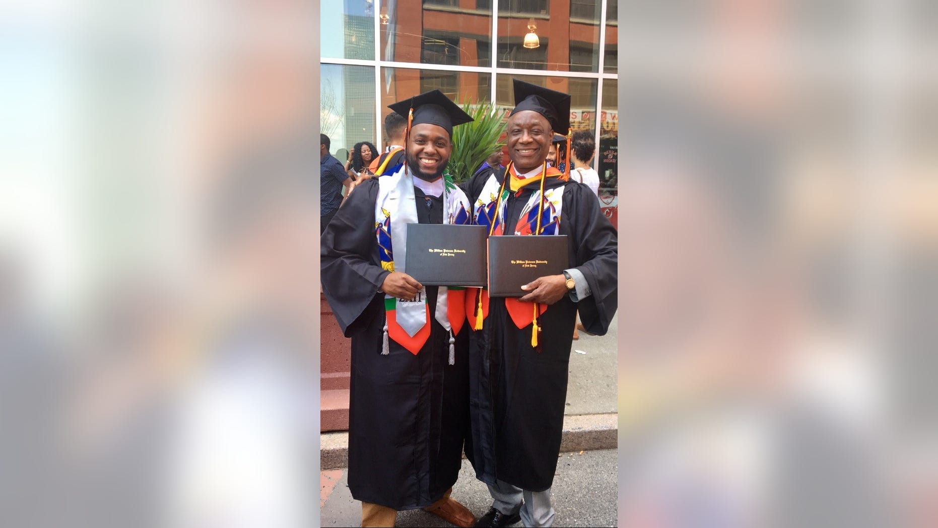 Ben Jeanty with his father, Duvinson, celebrating their graduation from William Paterson University.