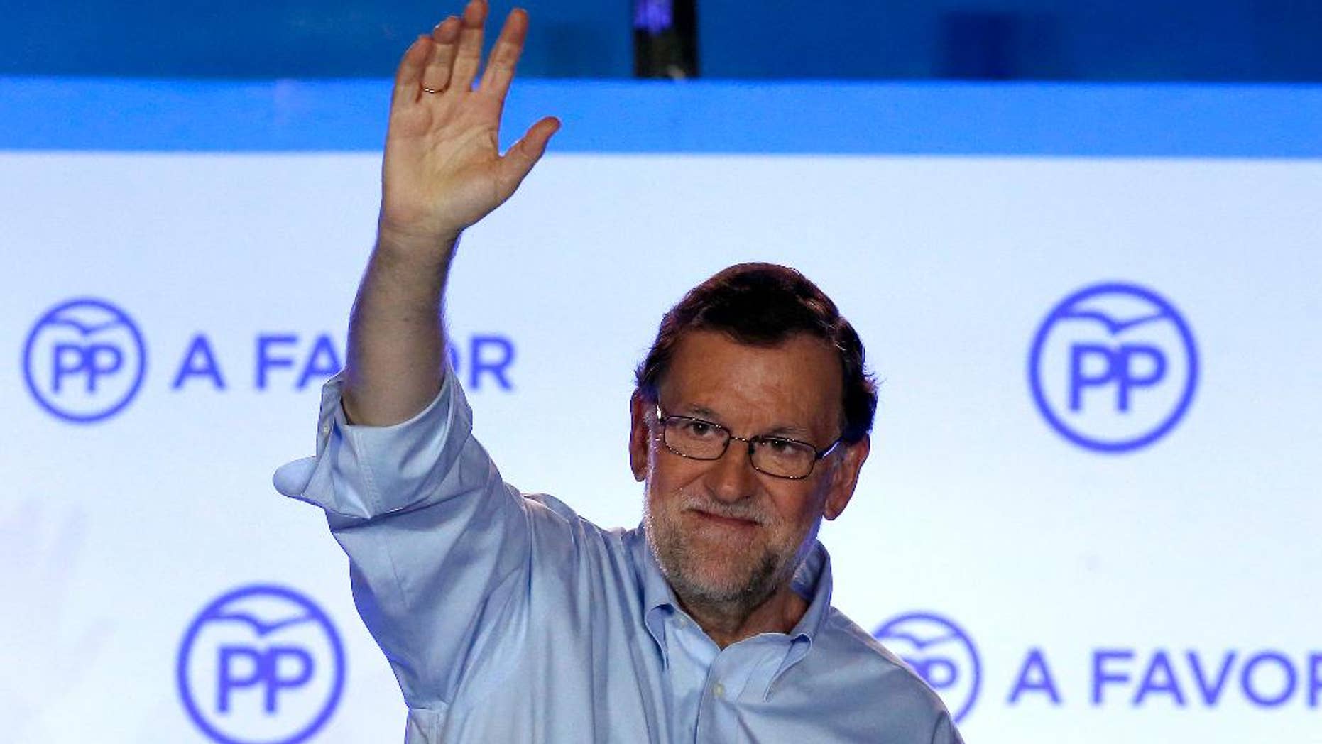 FILE - In this Sunday, June 26, 2016 file photo, Spain's then acting Primer Minister and candidate of Popular Party Mariano Rajoy, waves to his supporters as he celebrates the results of the party during the national elections in Madrid, Spain. Rajoy was re-elected as the leader of the conservative Popular Party for a fourth term on Saturday, Feb. 11, 2017. The 61-year-old Rajoy ran unopposed and won with 95% of the vote at the party congress in Madrid. (AP Photo/Daniel Ochoa de Olza, File)