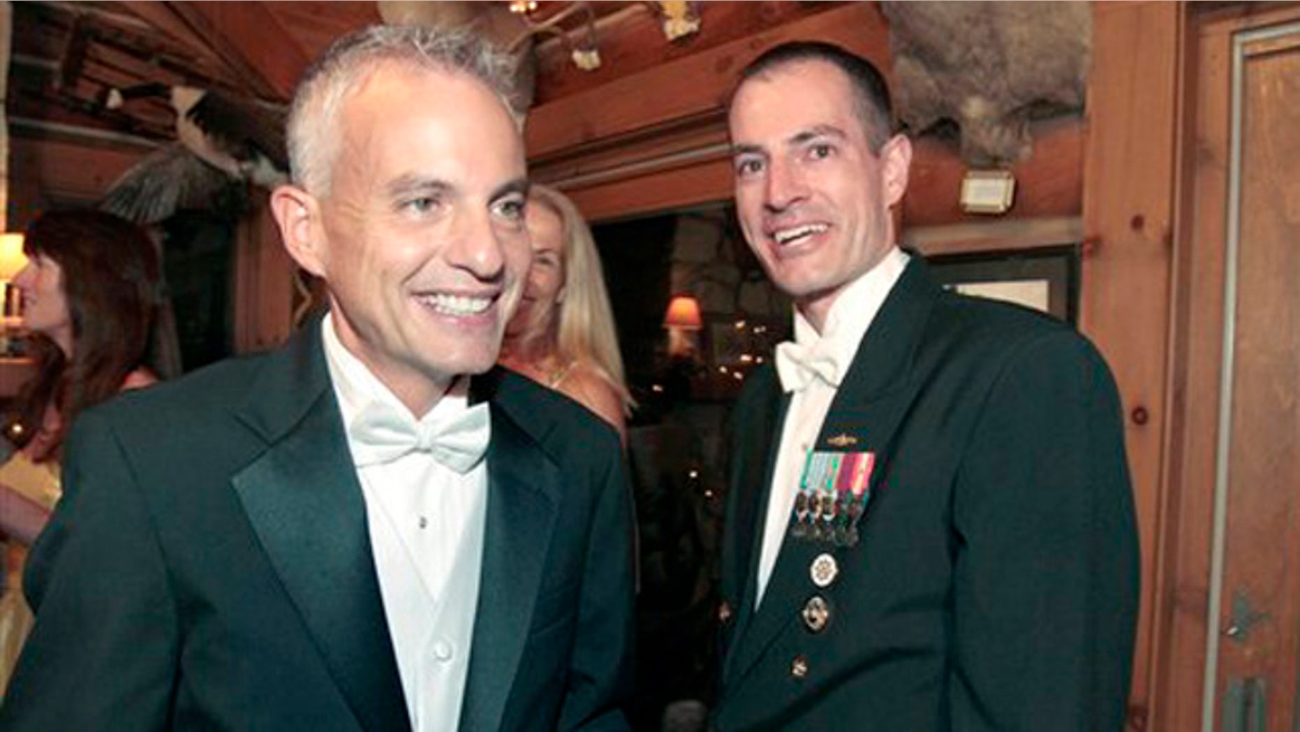 Navy Lt. Gary Ross, right, and Dan Swezy celebrate after exchanging wedding vows on Tuesday, Sept. 20, 2011 in Duxbury, Vt. The two men recited their vows at the first possible moment after the formal repeal of the military's "don't ask, don't tell policy." The partners of 11 years married at the stroke of midnight, just as the ban ended.