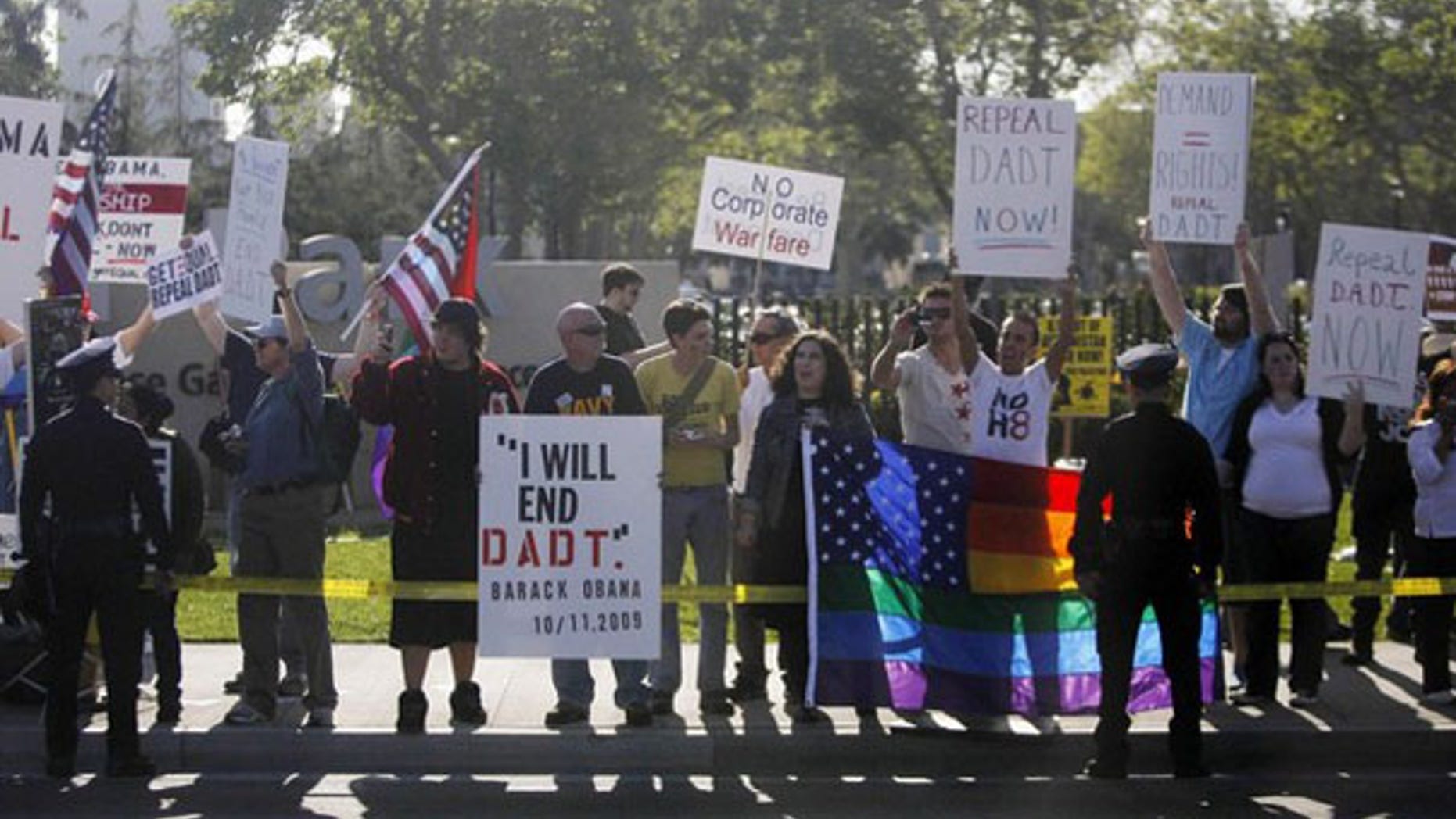 Protesters in favor of repealing the 'Don't Ask, Don't Tell' policy line the motorcade route of President Obama as he passes by in Los Angeles April 19. (Reuters Photo)