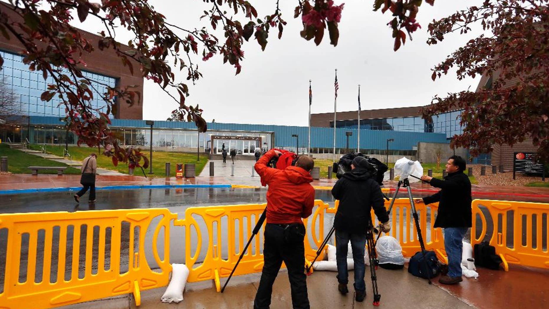 Television journalists film from within a media corral in front of the Arapahoe County Justice Center, on the first day of the trial of Aurora movie theater shootings defendant James Holmes, in Centennial, Colo., Monday April 27, 2015. As the trial begins, the key won't be whether he caused the carnage, but whether Holmes was sane at the time of the killings. (AP Photo/Brennan Linsley)