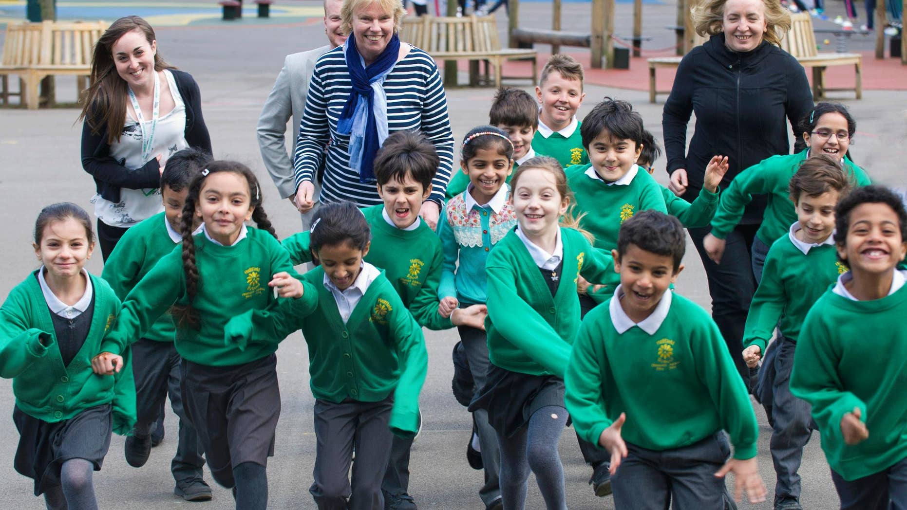 At the national launch of The Daily Mile in March 2016, founder Elaine Wyllie (center) runs with children at Hallfield Primary School in London.