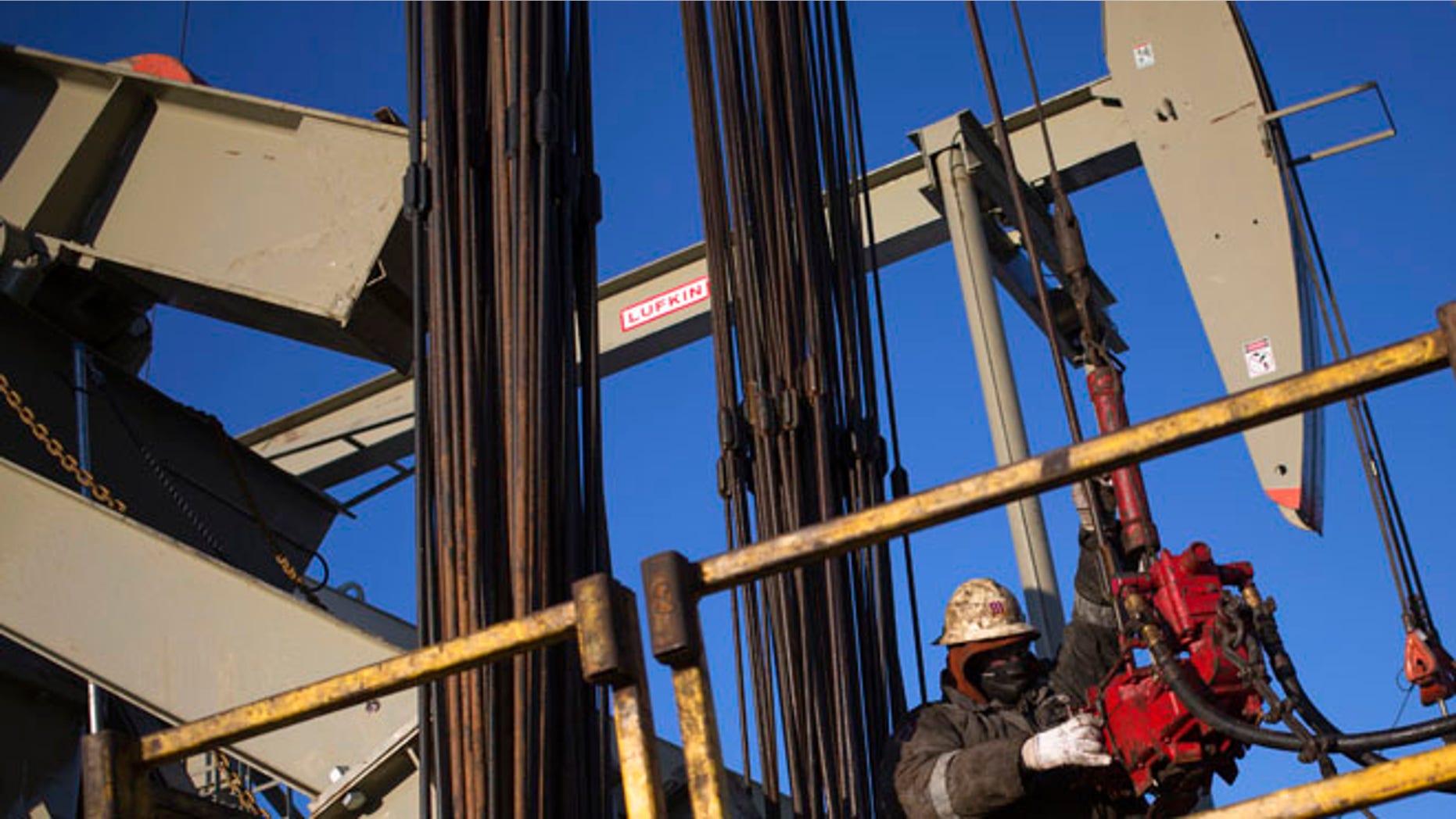Mar. 12, 2013:A man works on the rig of an oil drilling pump site in McKenzie County outside of Williston, North Dakota. (Reuters)