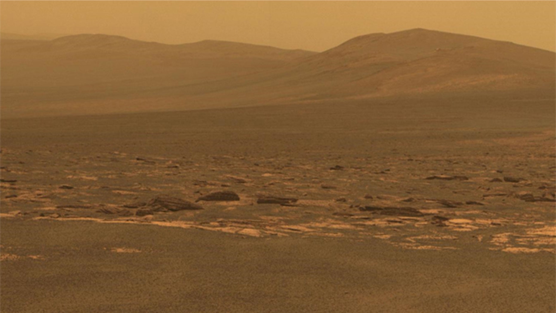 A portion of the west rim of Endeavour crater sweeps southward in this color view from NASA's Mars Exploration Rover Opportunity.