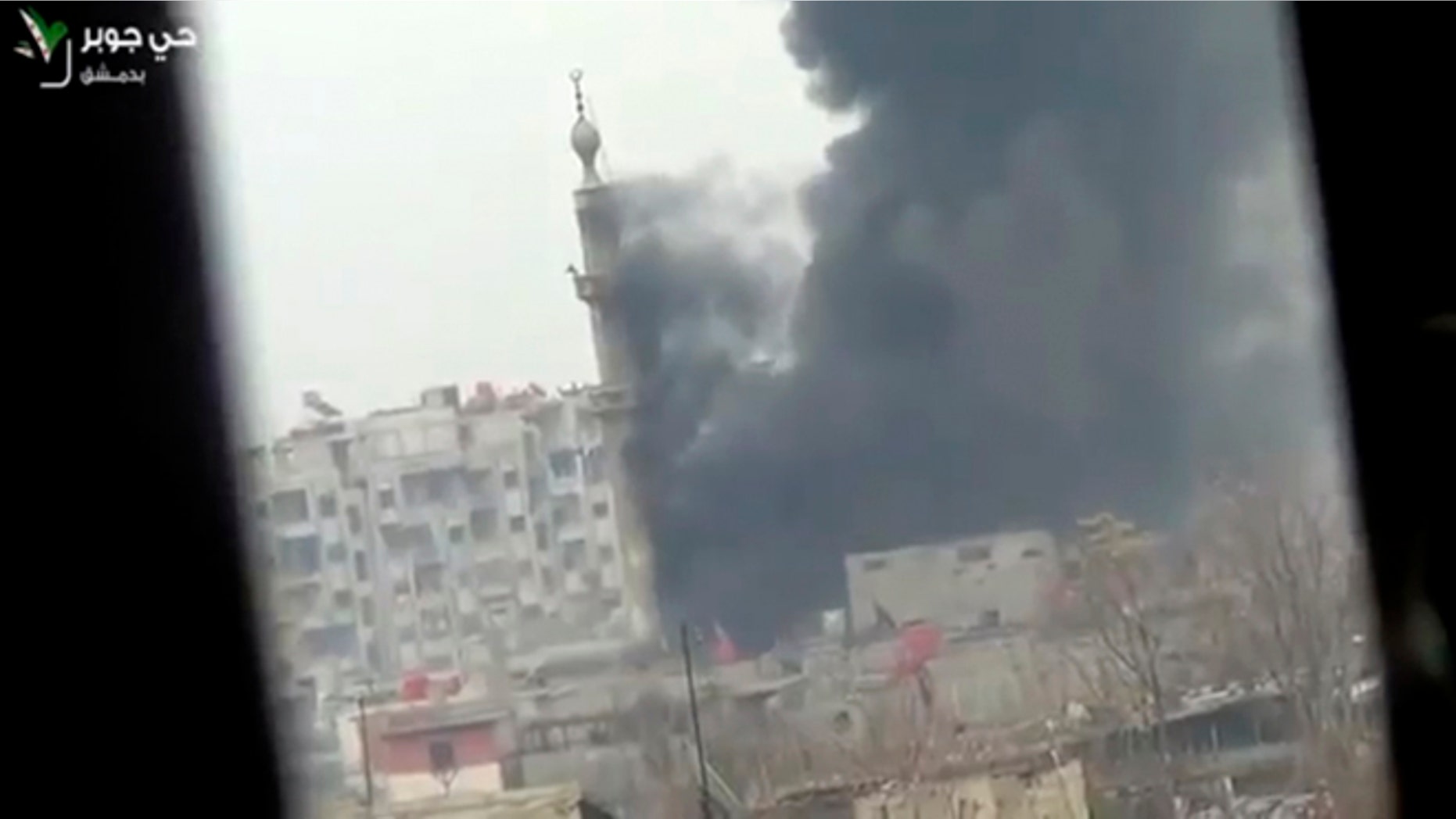 Feb. 6, 2013: This image taken from video obtained from Ugarit News, which has been authenticated based on its contents and other AP reporting, shows smoke and fire billowing from an explosion in Damascus, Syria.