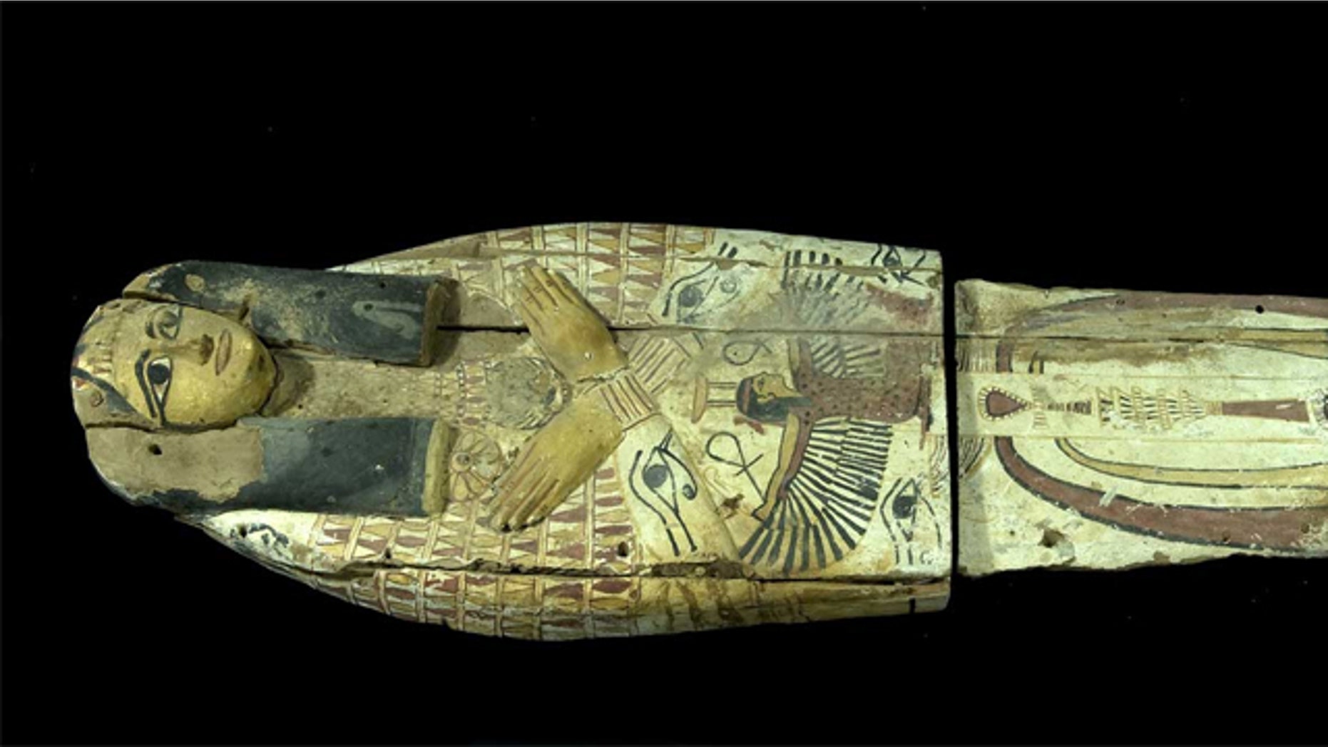 The wooden cover, which would have held a mummy in the past, had been cut in half, likely by smugglers who needed to fit the artifacts into a suitcase.