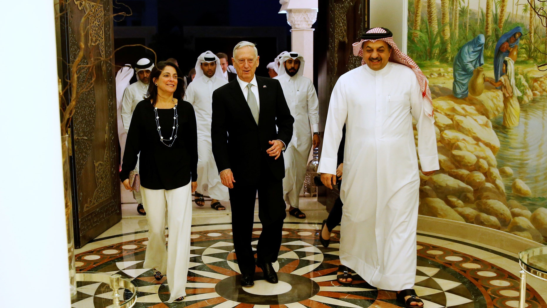 Qatar's Minister of Defence Khalid bin Mohammad Al-Attiyah (R) welcomes U.S. Defence Secretary James Mattis (C) and U.S. Ambassador to Qatar Dana Shell Smith (L) at his residence in Doha, Qatar April 22, 2017. REUTERS/Jonathan Ernst - RTS13GRB