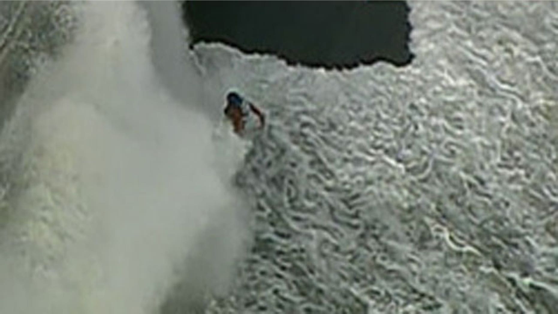 Sept. 30, 2011: A cyclist is hit by a wave while traveling along the Lake Michigan jogging path.