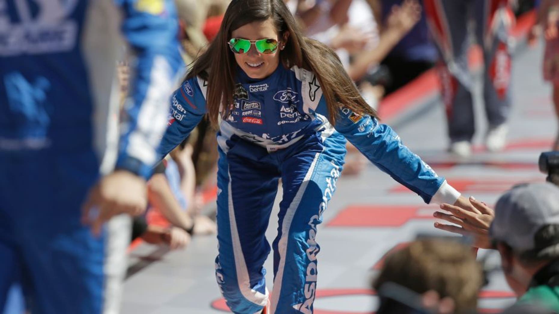 Danica Patrick greets fans before the NASCAR Daytona 500 auto race at Daytona International Speedway in Daytona Beach, Fla., Sunday, Feb. 26, 2017. (AP Photo/John Raoux)