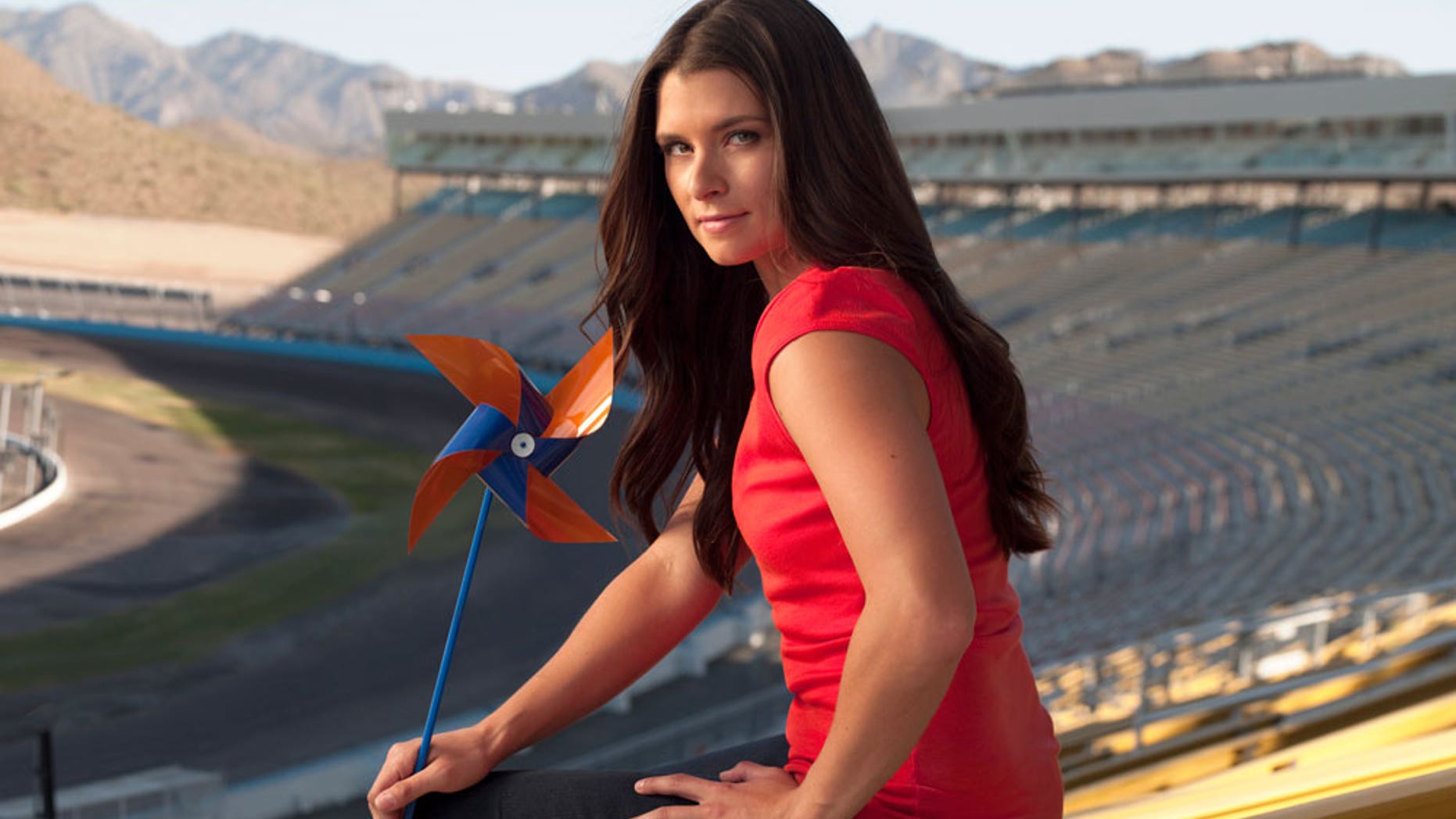 Danica Patrick holds a pinwheel, the symbol for COPD awareness