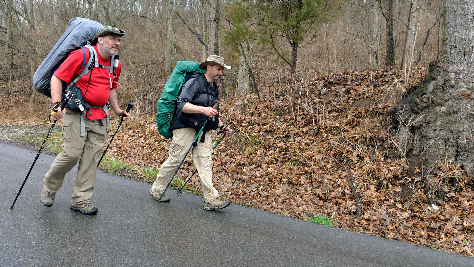 March 26, 2015: Curtis Penix, left and his walking partner Givan Fox walk Kentucky State Road 388 following the Boone Trace near Fort Boonesborough, Ky.
