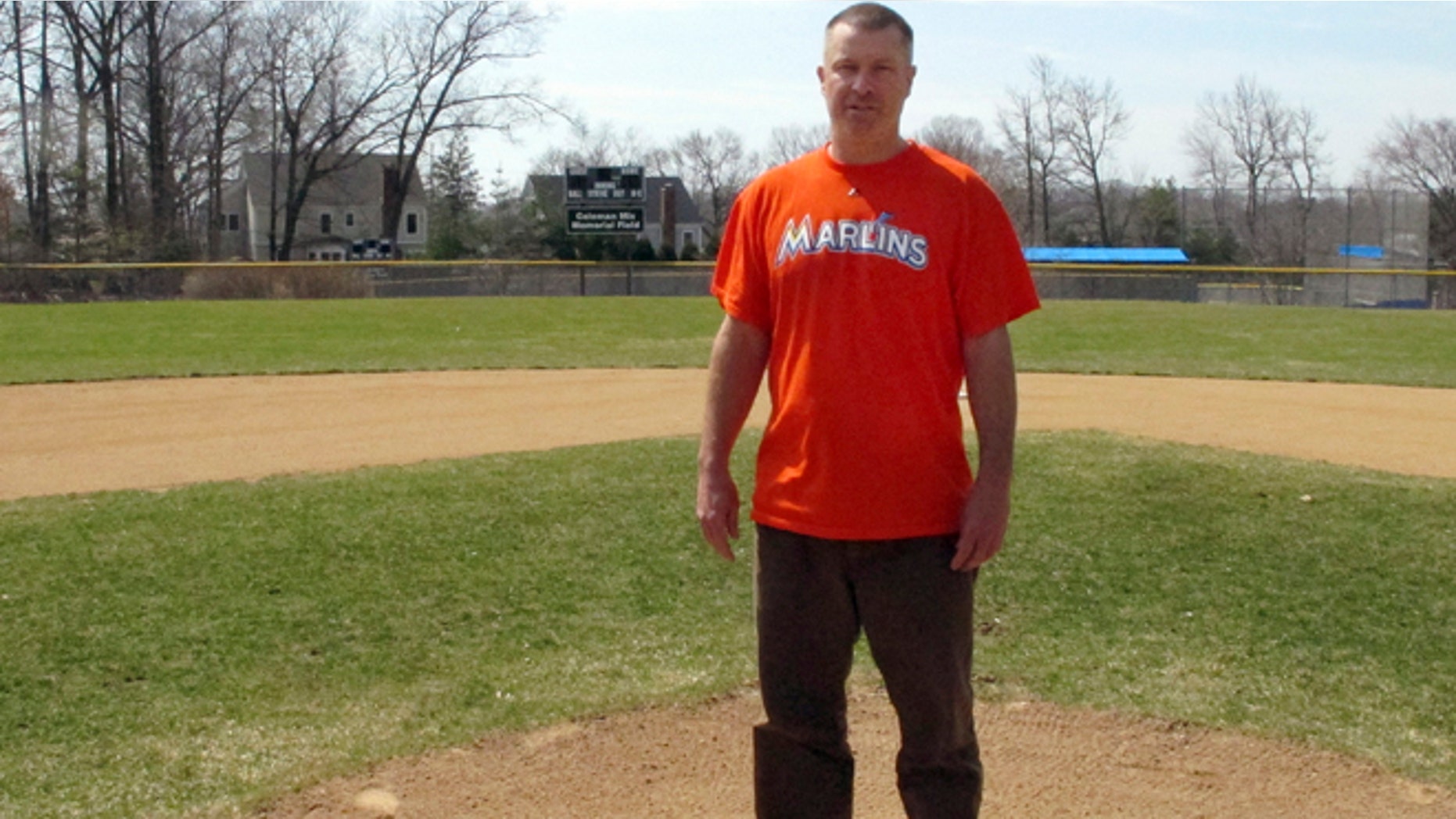 April 6, 2015: Christopher Stefanoni poses at the Darien Little League park in Darien, Conn. Stefanoni is suing the Darien Little League in federal court, saying league officials demoted his 9-year-old son to a lower-level team as retribution for his affordable housing proposal. Lawyers for the Little League deny the allegations.