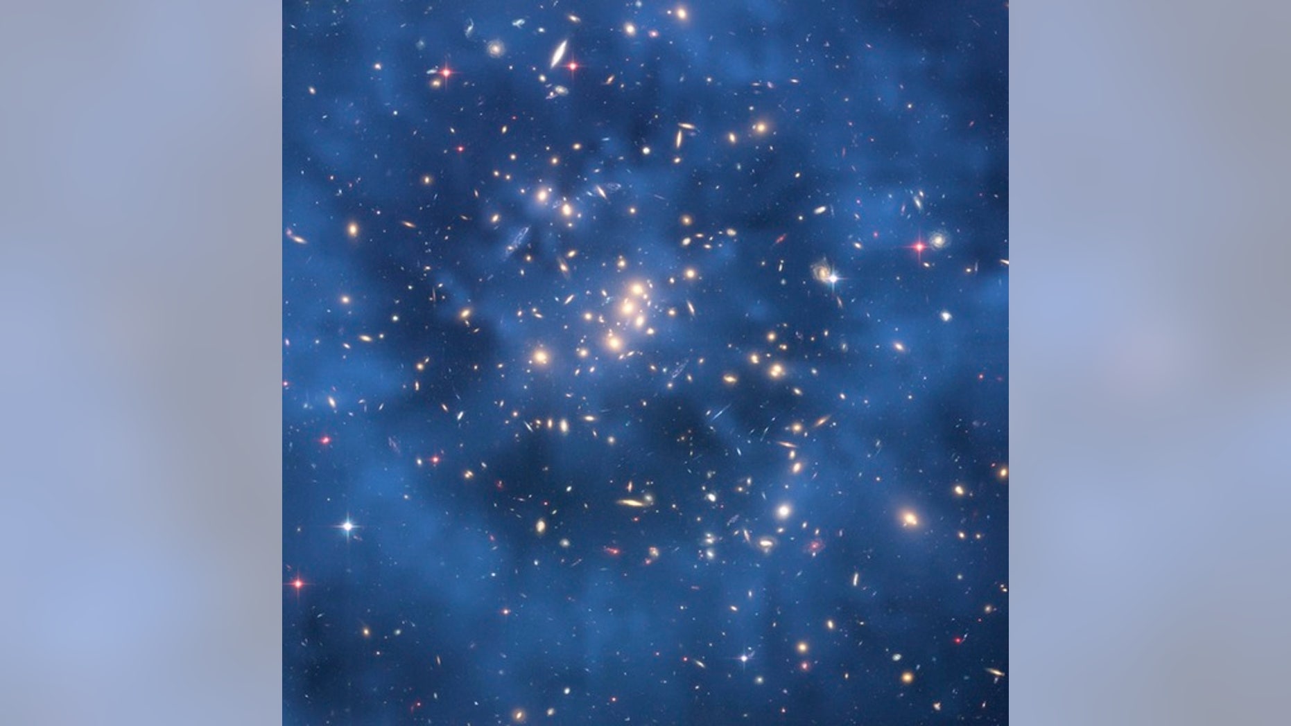 This Hubble Space Telescope composite image shows a ghostly "ring" of dark matter in the galaxy cluster Cl 0024+17.