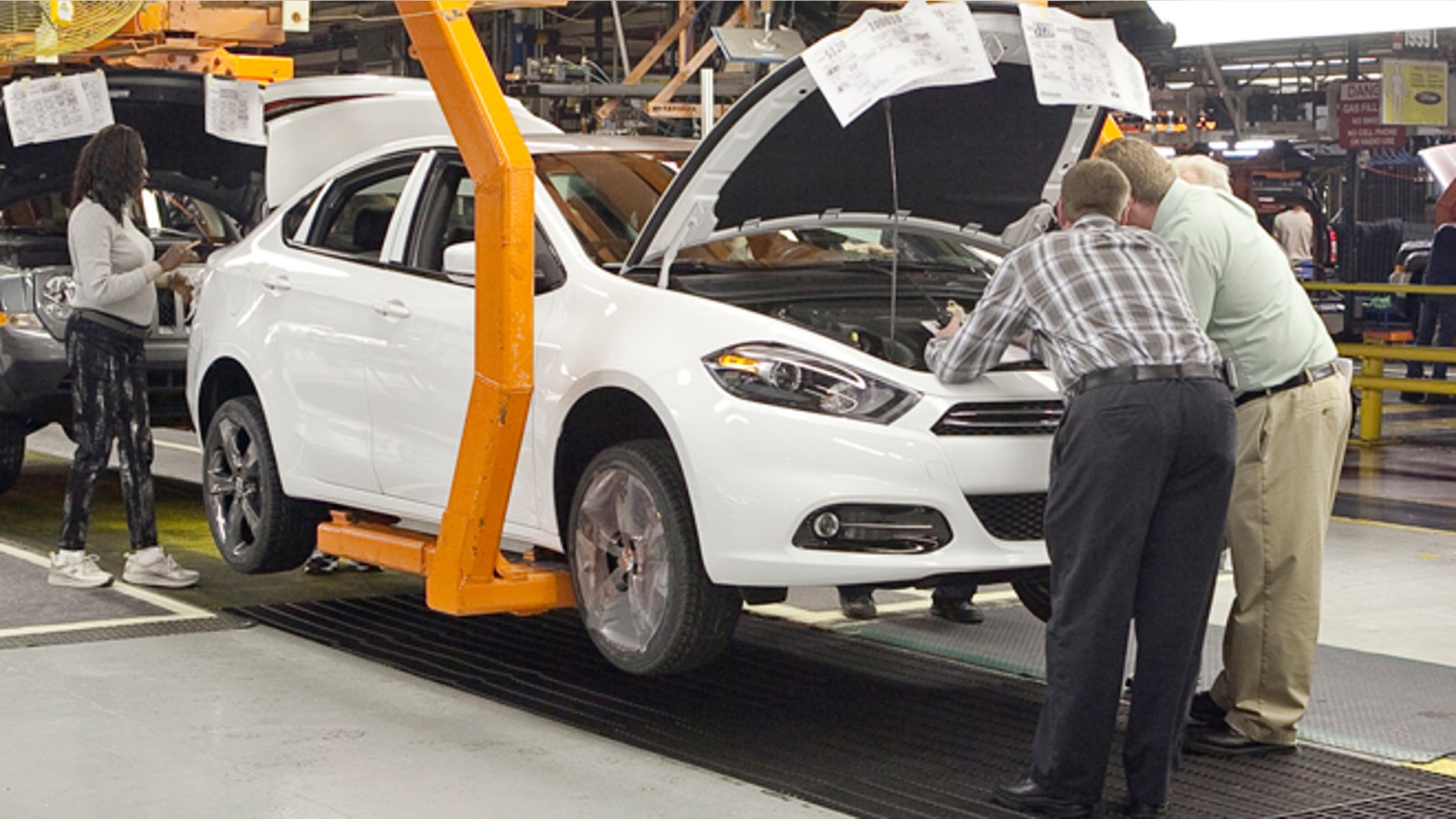 Workers manufacture a pre-production 2013 Dodge Dart.
