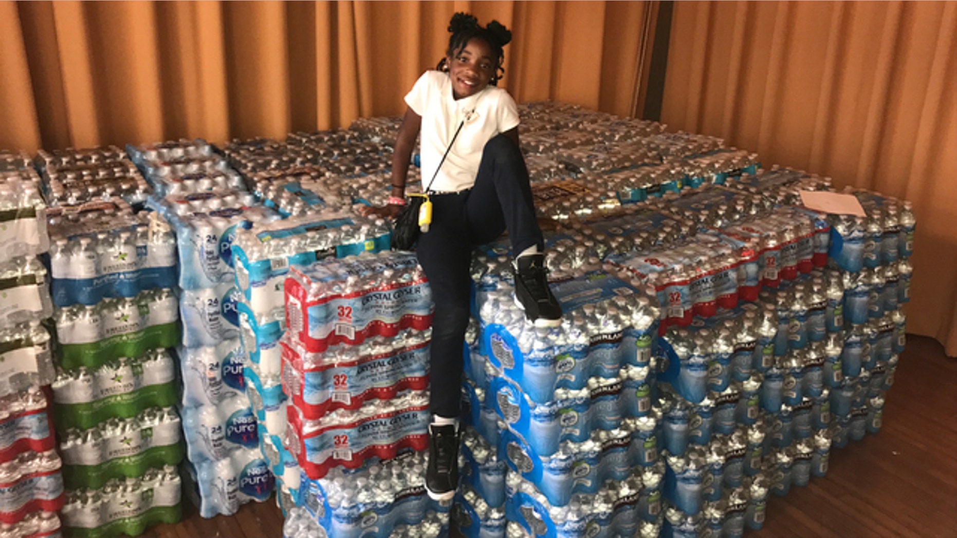 Dashai Morton, 12, with her donations to hurricane victims in Puerto Rico.