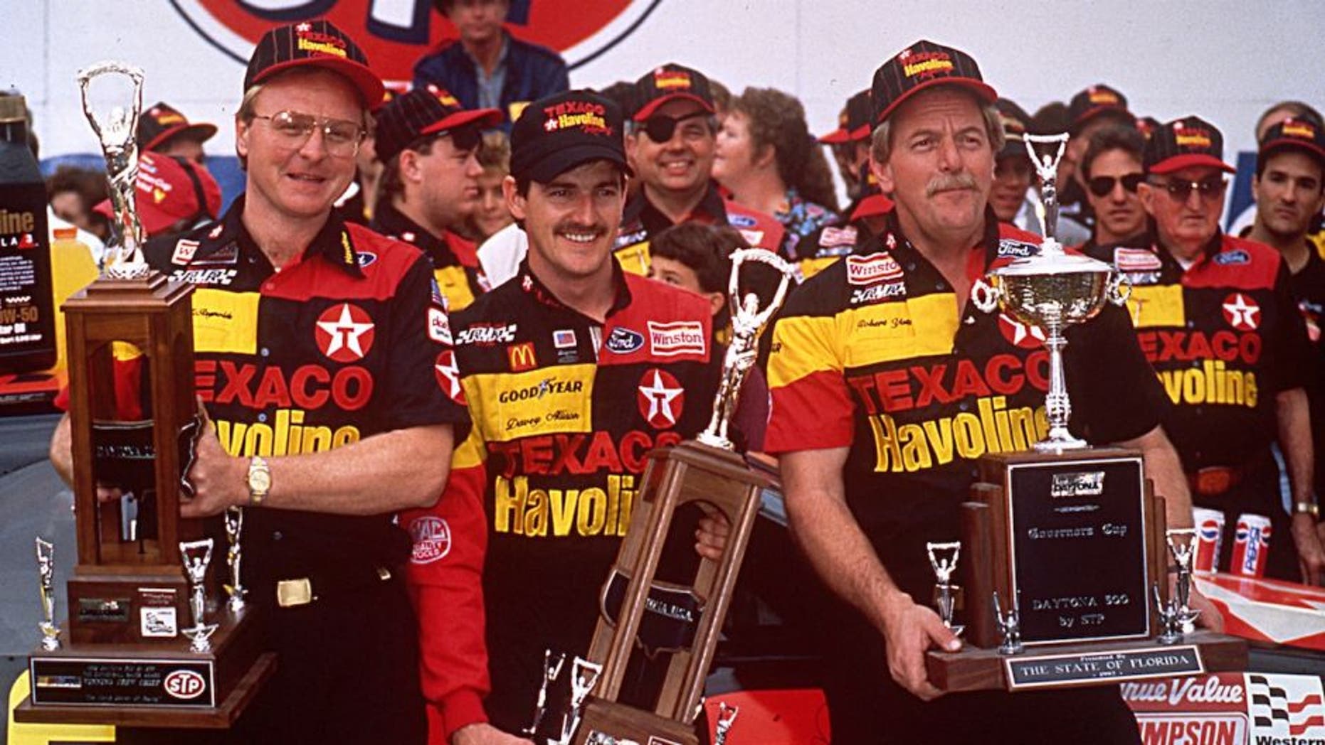 DAYTONA BEACH, FL â February 16, 1992: Davey Allison (C) celebrates in victory lane at Daytona International Speedway with crew chief Larry McReynolds (L) and car owner Robert Yates (R) after winning the Daytona 500 NASCAR Cup race. (Photo by ISC Images & Archives via Getty Images)