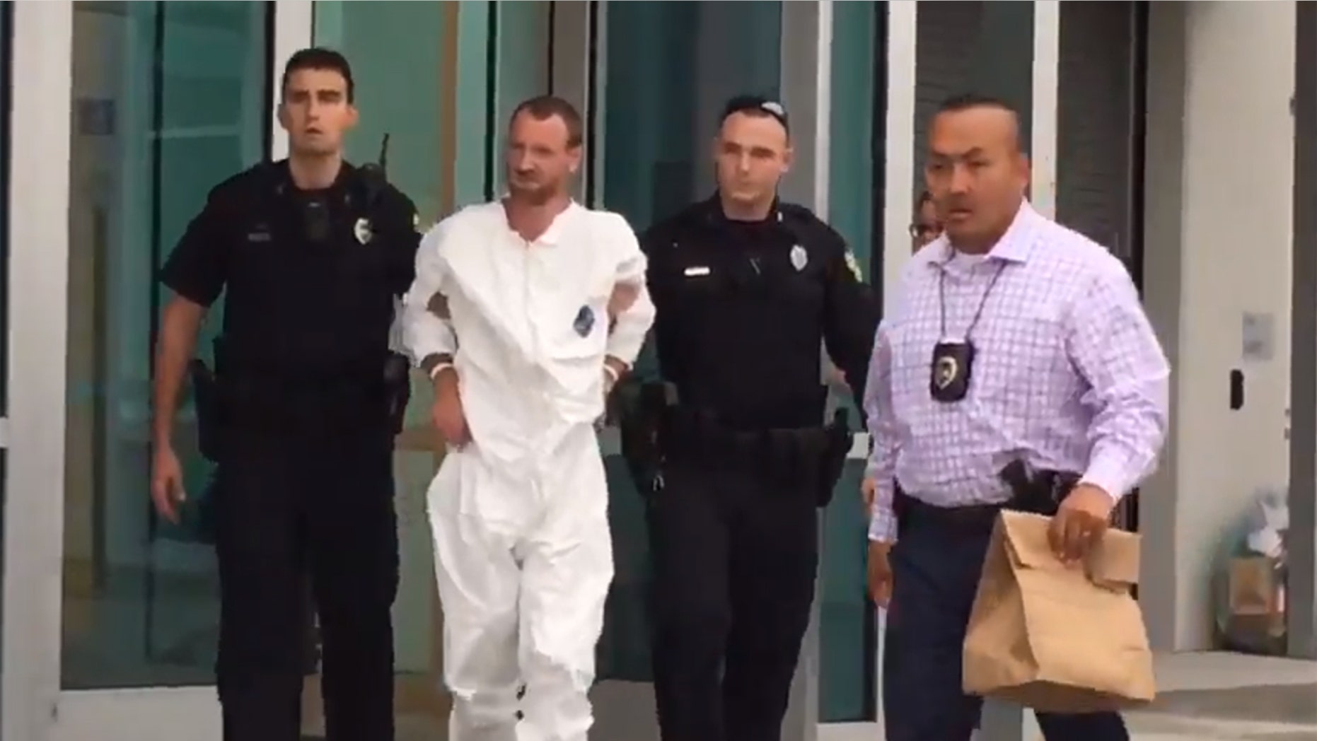 David Gray is led to an Orlando police car.