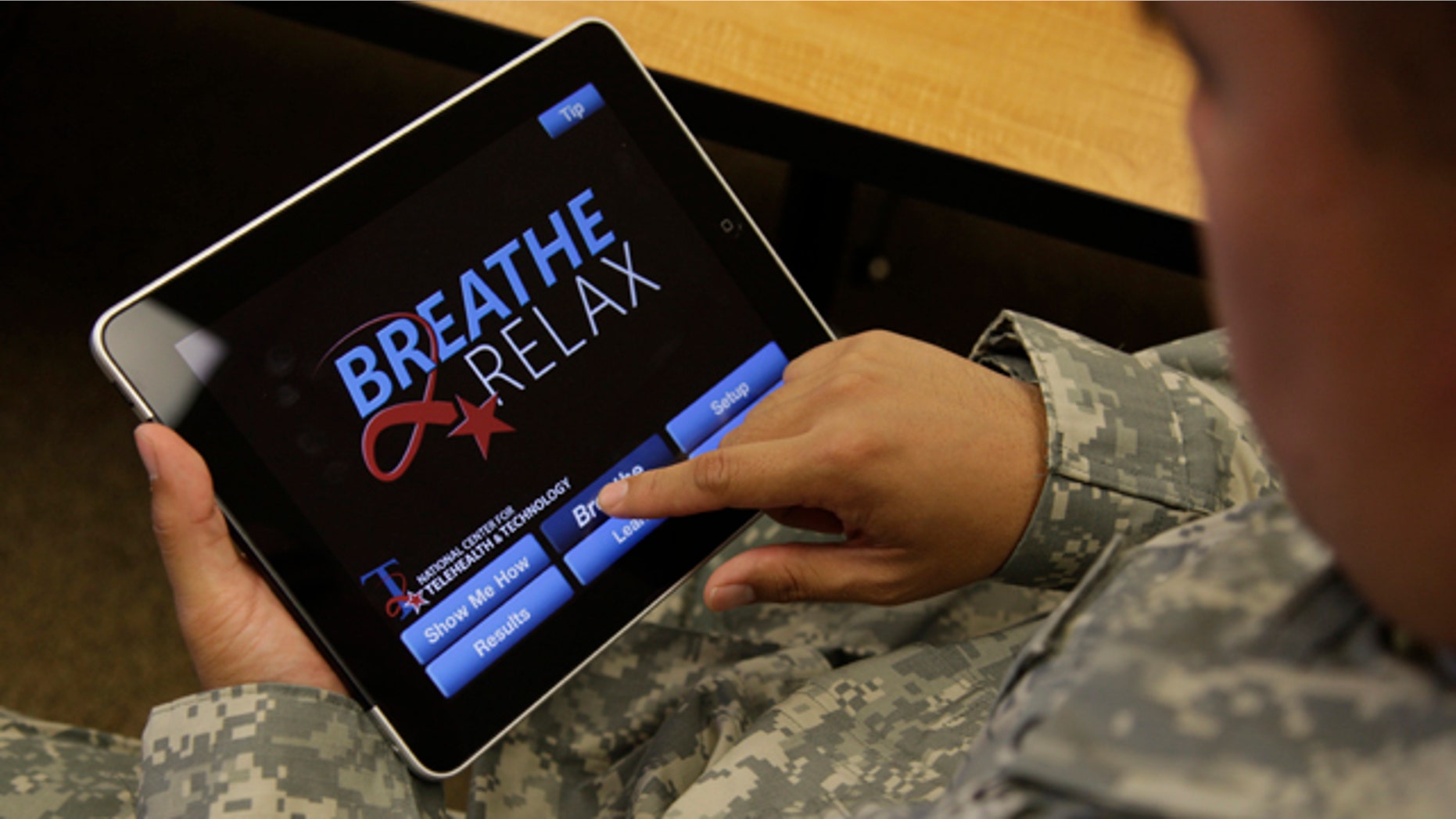 Sgt. Mark Miranda demonstrates the use of a new app that is designed to help calm symptoms of post-traumatic stress and traumatic brain injury.