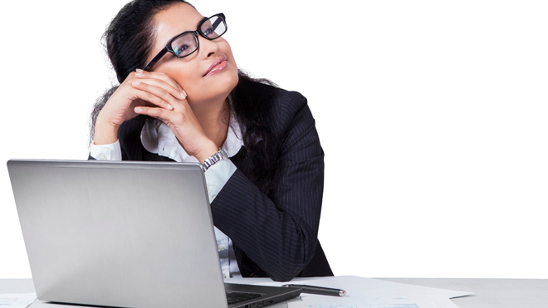 Portait of female entrepreneur working on desk while daydreaming, isolated on white background