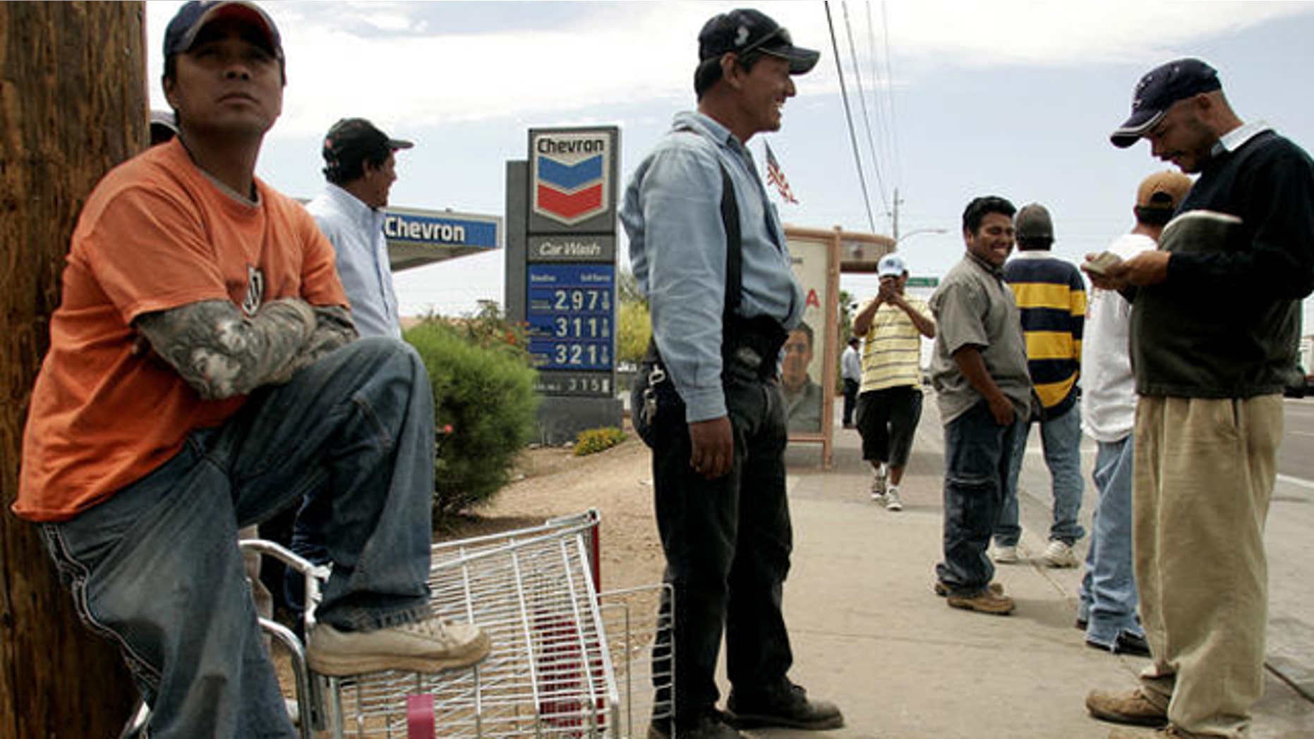 Day laborers wait for work near a Home Depot store in Phoenix.