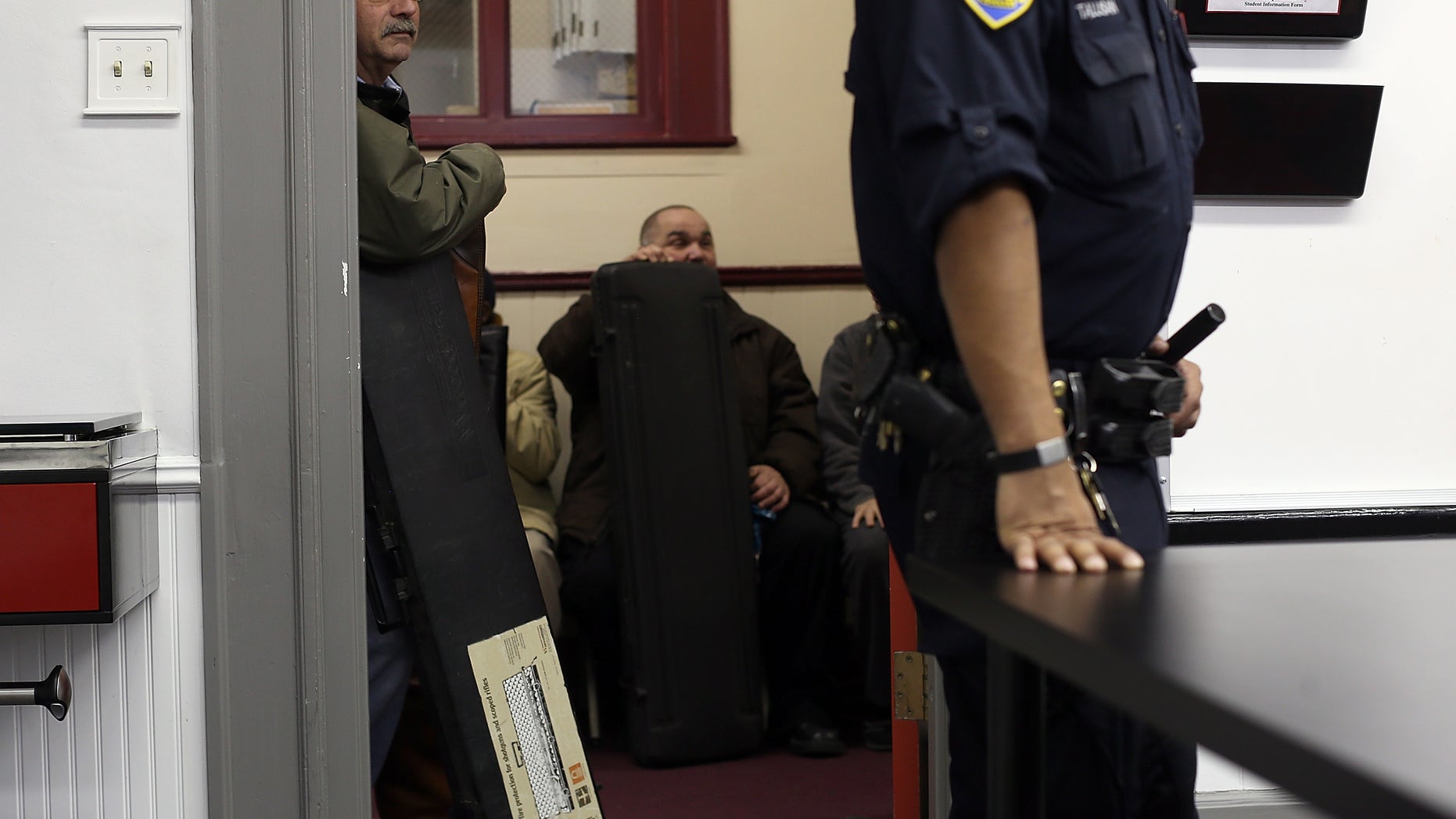 SAN FRANCISCO, CA - DECEMBER 15: People wait in line to turn in firearms during a gun buy back program on December 15, 2012 in San Francisco, California. The San Francisco police department held a one-day gun buy back event that paid $200 per gun turned in. A better than expected crowd resulted in payback money running out and vouchers were issued to collect money within a week. Over 200 guns were collected. (Photo by Justin Sullivan/Getty Images)