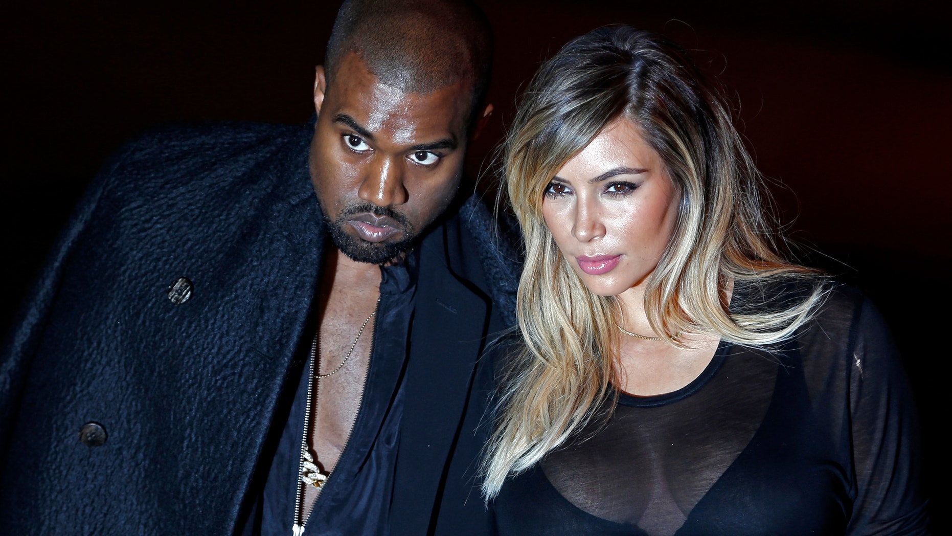 U.S. musician Kanye West and companion Kim Kardashian arrive at the Givenchy Spring/Summer 2014 women's ready-to-wear fashion show during Paris Fashion Week September 29, 2013