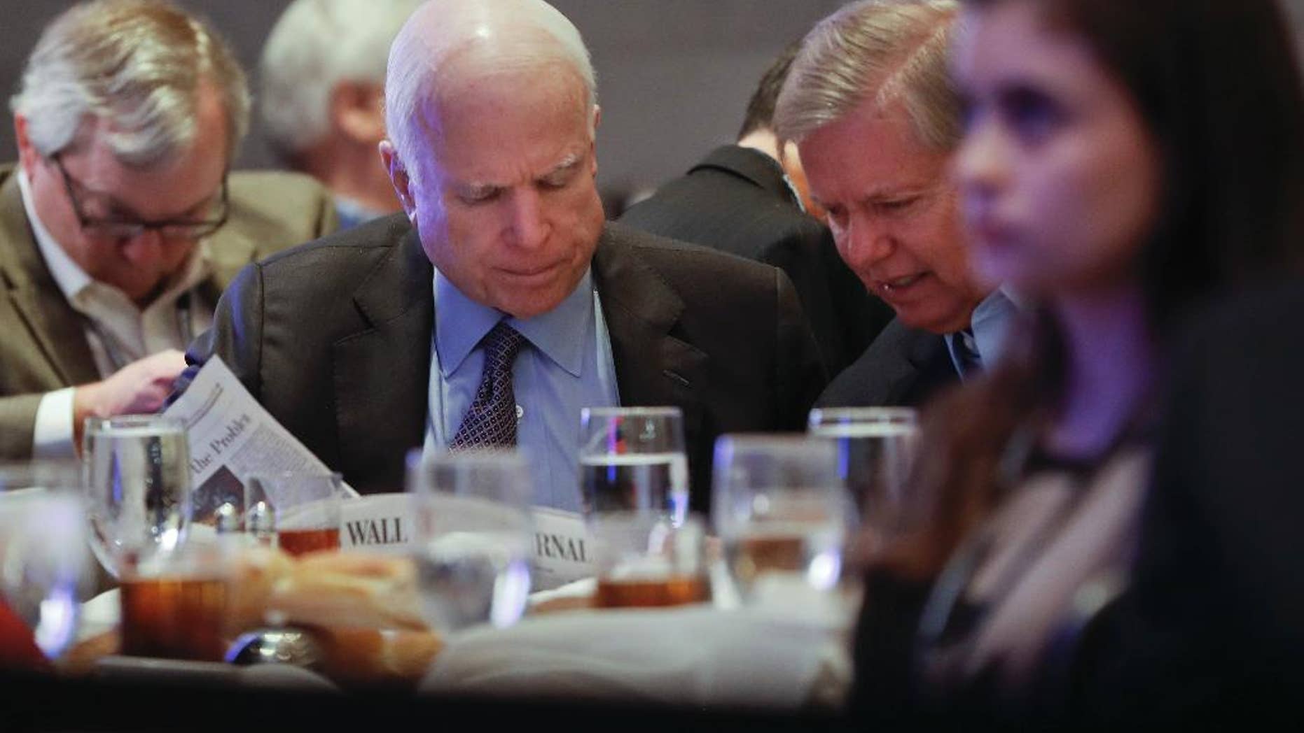 In this Jan. 26, 2017, photo, Sen. John McCain, R-Ariz., left, and Sen. Lindsey Graham, R-S.C., right, read the Wall Street Journal newspaper as they wait for President Donald Trump to speak at the House and Senate GOP lawmakers at the annual policy retreat in Philadelphia. McCain has emerged as Trump’s top Republican nemesis on Capitol Hill. Since Trump’s inauguration, McCain has broken with the president on his immigration order, warned him against any rapprochement with Moscow and lectured him on the illegality of torture. He supplied only a tepid endorsement of Rex Tillerson, Trump’s secretary of state nominee. (AP Photo/Pablo Martinez Monsivais)