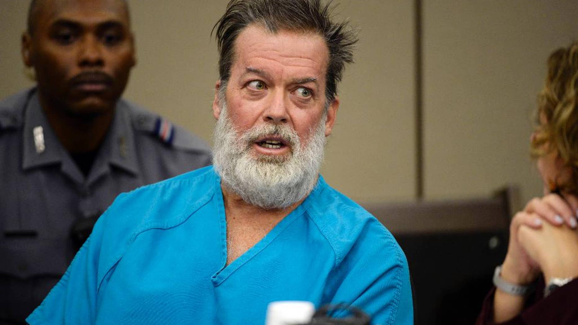 FILE - In this Dec. 9, 2015 file photo, Robert Lewis Dear, middle, talks during a court appearance in Colorado Springs, Colo. The man who acknowledges killing three people at a Colorado Planned Parenthood clinic will return to court for a discussion of his mental health. The Thursday, April 28, 2016 hearing will focus on whether 57-year-old Dear is competent to continue with his criminal case. (Andy Cross/The Denver Post via AP, Pool, File)