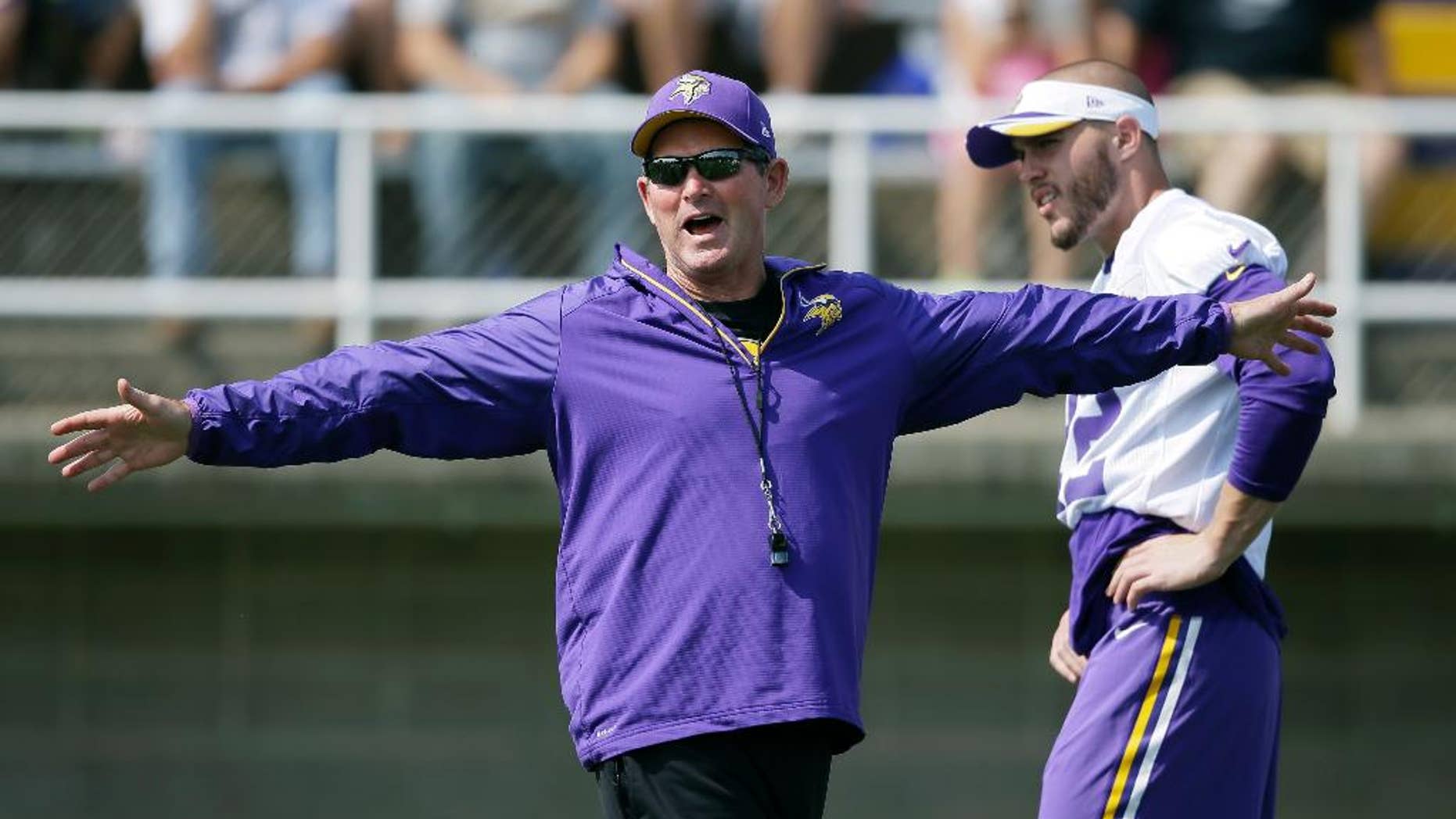 Minnesota Vikings head coach Mike Zimmer directs his team as free safety Harrison Smith, right, looks on during an NFL football training camp practice, Saturday, Aug. 2, 2014, in Mankato, Minn. (AP Photo/Charlie Neibergall)