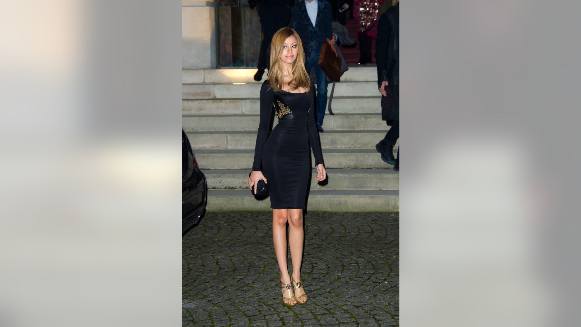 Fashion designer Zahia Behar leaves after attending attend the Atelier Versace Spring-Summer 2014 Haute Couture fashion collection, presented Sunday, Jan. 19, 2014 in Paris. (AP Photo/Zacharie Scheurer)