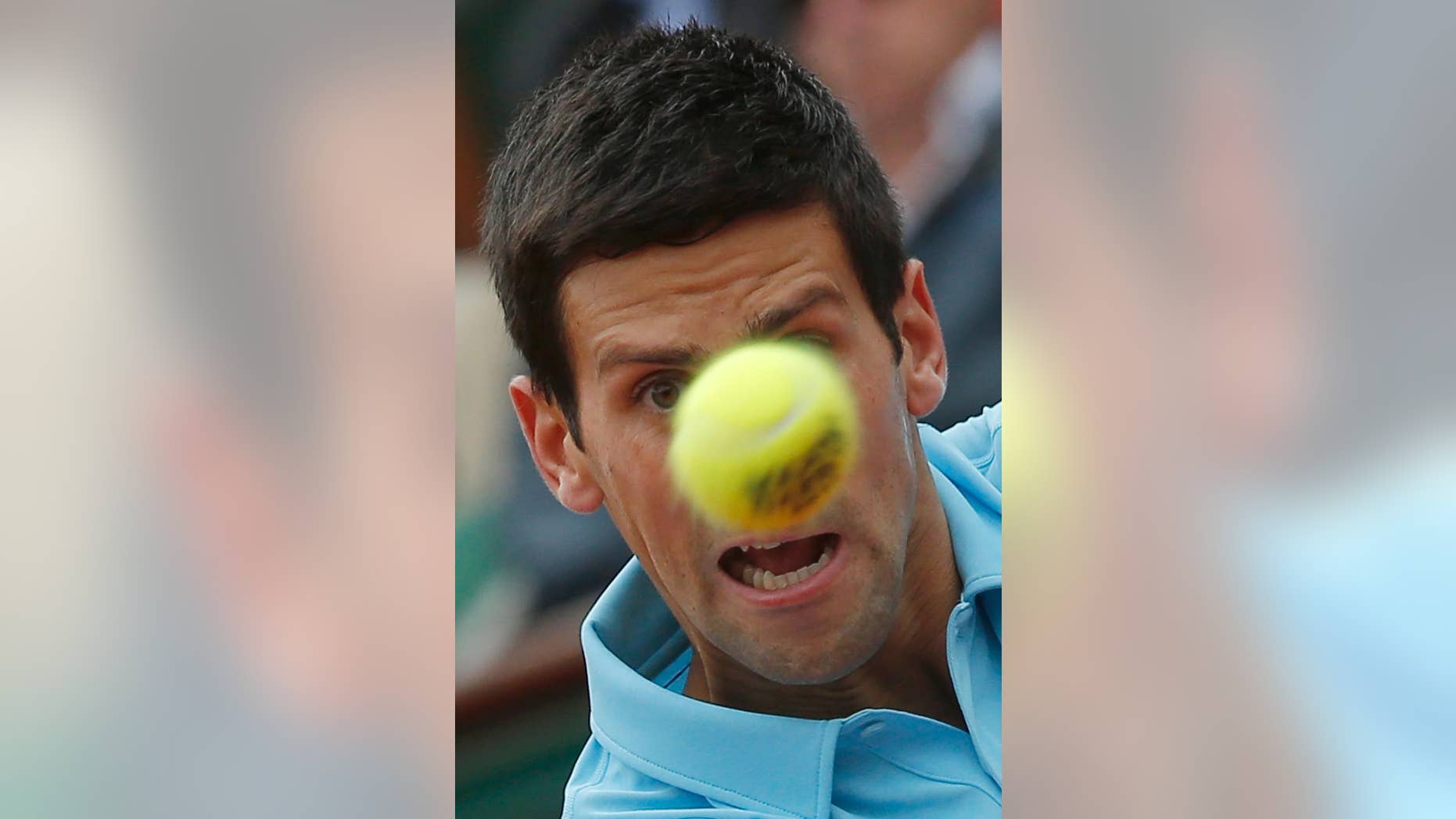 Serbia's Novak Djokovic eyes the ball as he returns during the first round match of the French Open tennis tournament against Portugal's Joao Sousa at the Roland Garros stadium, in Paris, France, Monday, May 26, 2014. (AP Photo/Michel Euler)