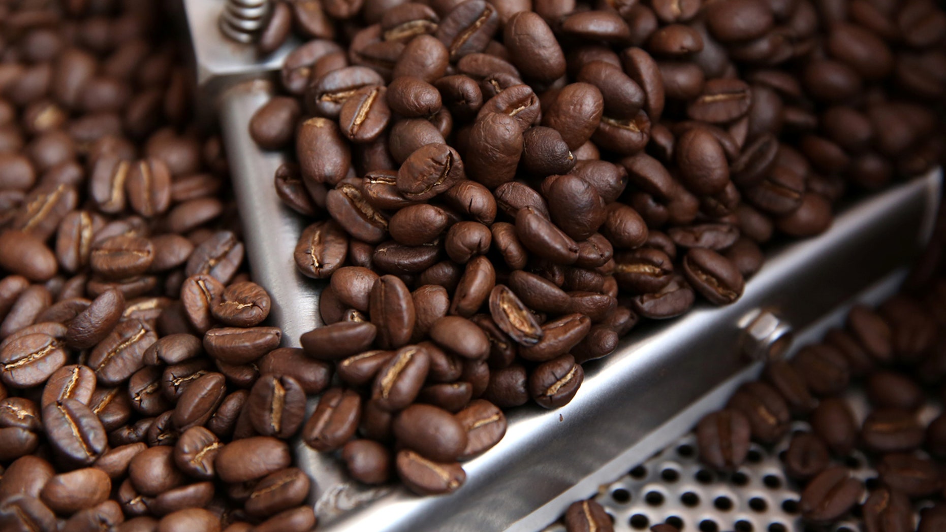 FILE: Coffee beans are seen in a roaster.
