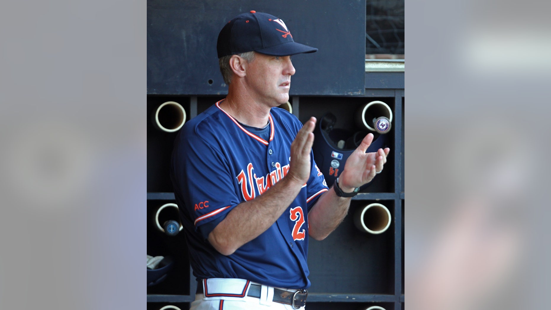 FILE - In this June 1, 2013, file photo, Virginia coach Brian O'Connor claps in the dugout during the fifth inning of an NCAA college baseball tournament regional game against Elon in Charlottesville, Va. O'Connor looked at his schedule, looked at how much talent was on his roster and knew he needed to make a change. A few phone calls later, O'Connor's Virginia baseball team no longer planned to open the season with a non-descript three-game series at home, but in a tournament in Wilmington, N.C., with three other quality programs. (AP Photo/Andrew Shurtleff, File)