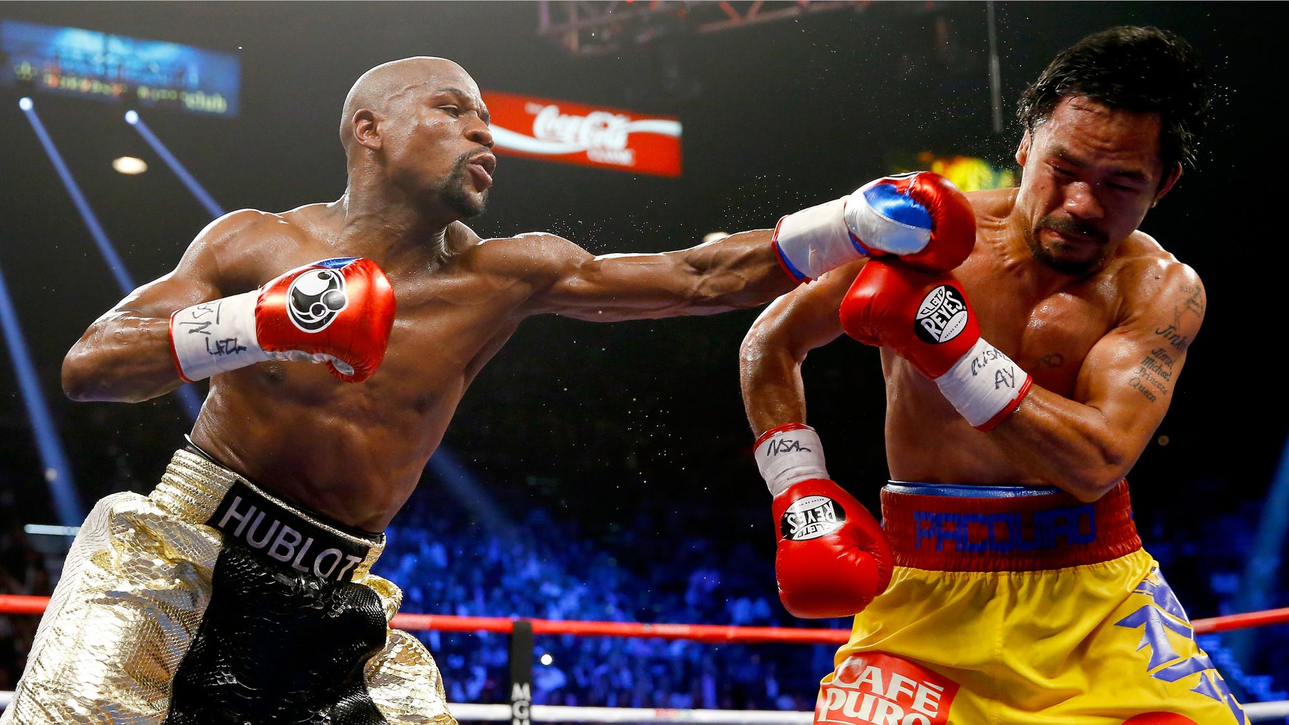 LAS VEGAS, NV - MAY 02: Floyd Mayweather Jr. throws a left at Manny Pacquiao during their welterweight unification championship bout on May 2, 2015 at MGM Grand Garden Arena in Las Vegas, Nevada. (Photo by Al Bello/Getty Images)