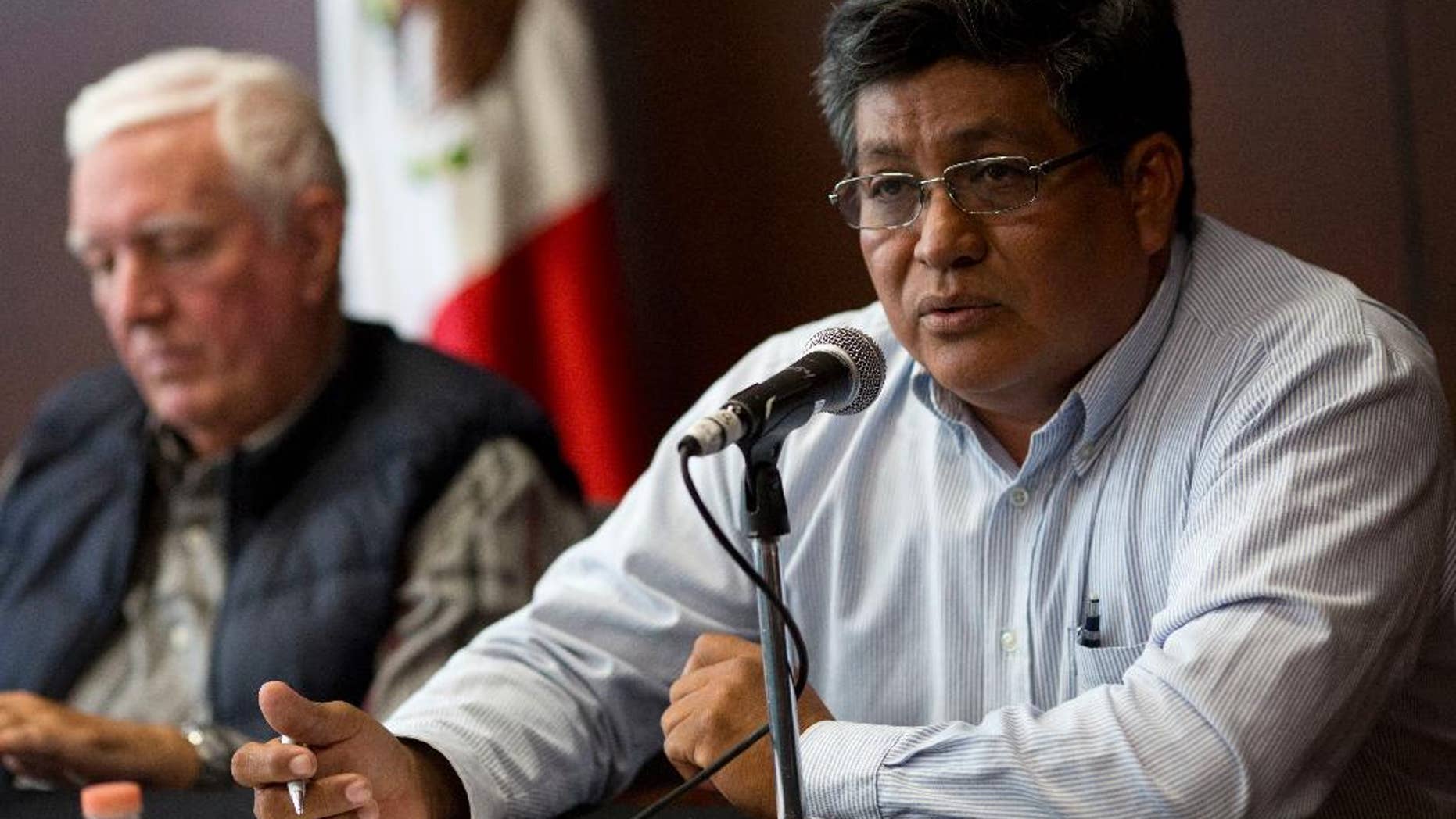 Luis Pantoja, archeologist with the National Institute of Anthropology and History, speaks as fellow archaelogist Luis Millet listens during a press conference at the Museum of Anthropology in Mexico City, Tuesday, April 5, 2016. The archaeologists said that they are racing to keep up with development on the Yucatan peninsula as suburbs of the colonial city of Merida swallow Maya settlements. (AP Photo/Rebecca Blackwell)