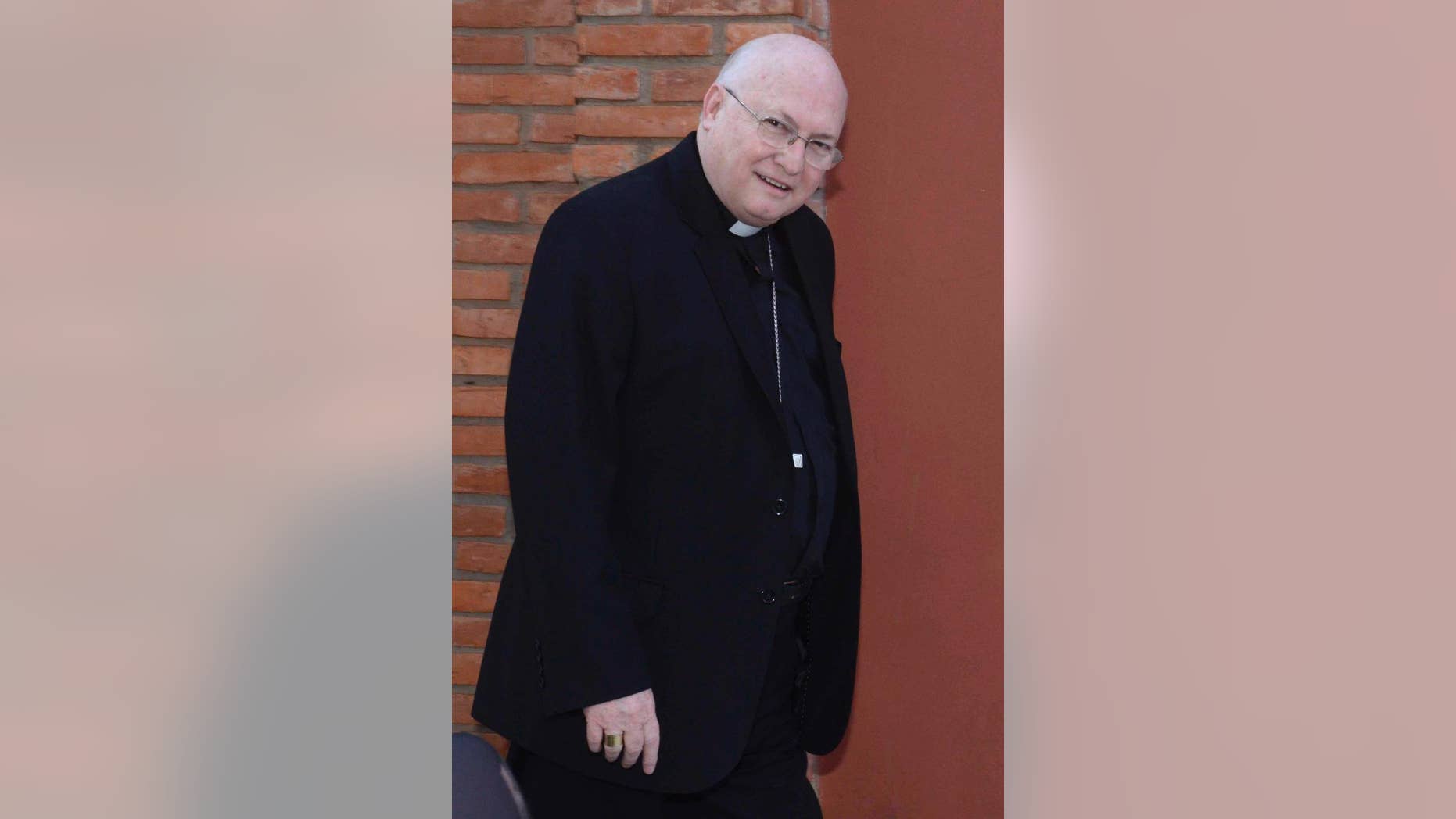 In this July 25, 2014 photo, Bishop Rogelio Ricardo Livieres Plano walks to church in Ciudad del Este, Paraguay. Livieres Plano, a member of the conservative Opus Dei movement, has been removed by Pope Francis from a Paraguayan diocese said the Vatican Thursday, Sept. 25, 2014, after he clashed with his fellow bishops by opening his own seminary and promoting an Argentine priest accused of inappropriate sexual behavior. (AP Photo/ABC, Raul Gonzalez)