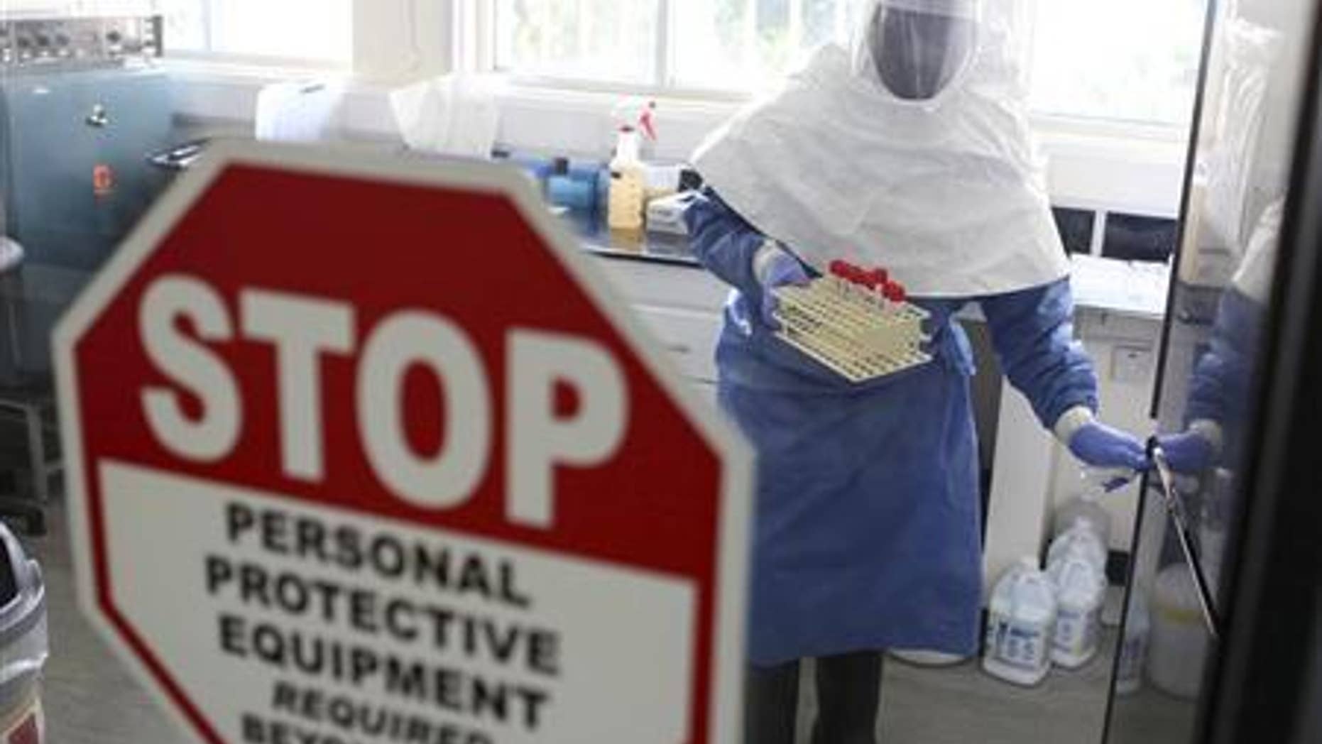 A doctor works in a laboratory on collected samples of the Ebola virus at the Centre for Disease Control in Entebbe, about 37 km (23 miles) southwest of Uganda's capital Kampala, August 2, 2012. REUTERS/Edward Echwalu