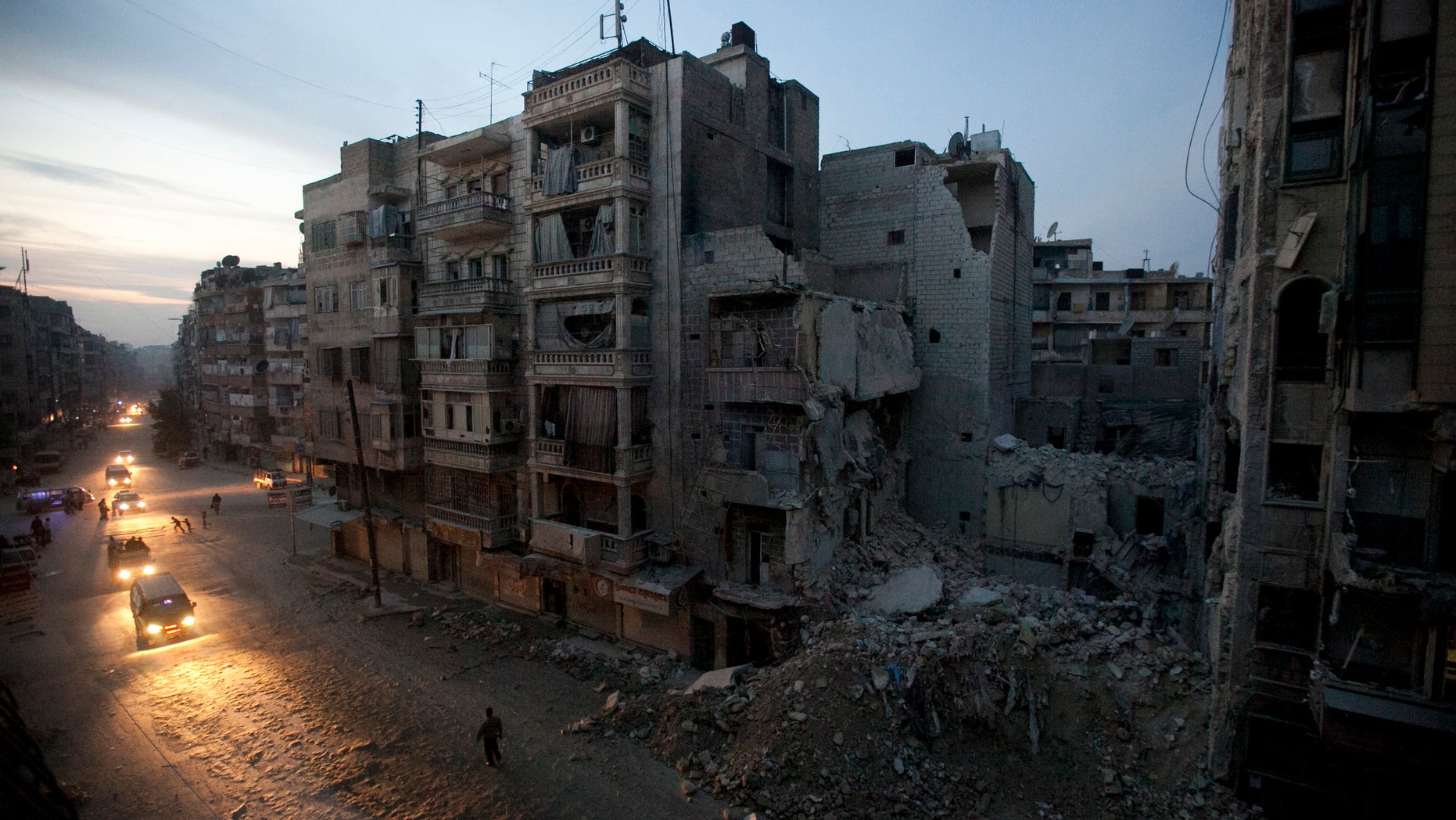 Nov. 29, 2012: Night falls on a Syrian rebel-controlled area of Aleppo as destroyed buildings, including Dar Al-Shifa hospital, are seen on Sa'ar street after airstrikes targeted the area a week before.