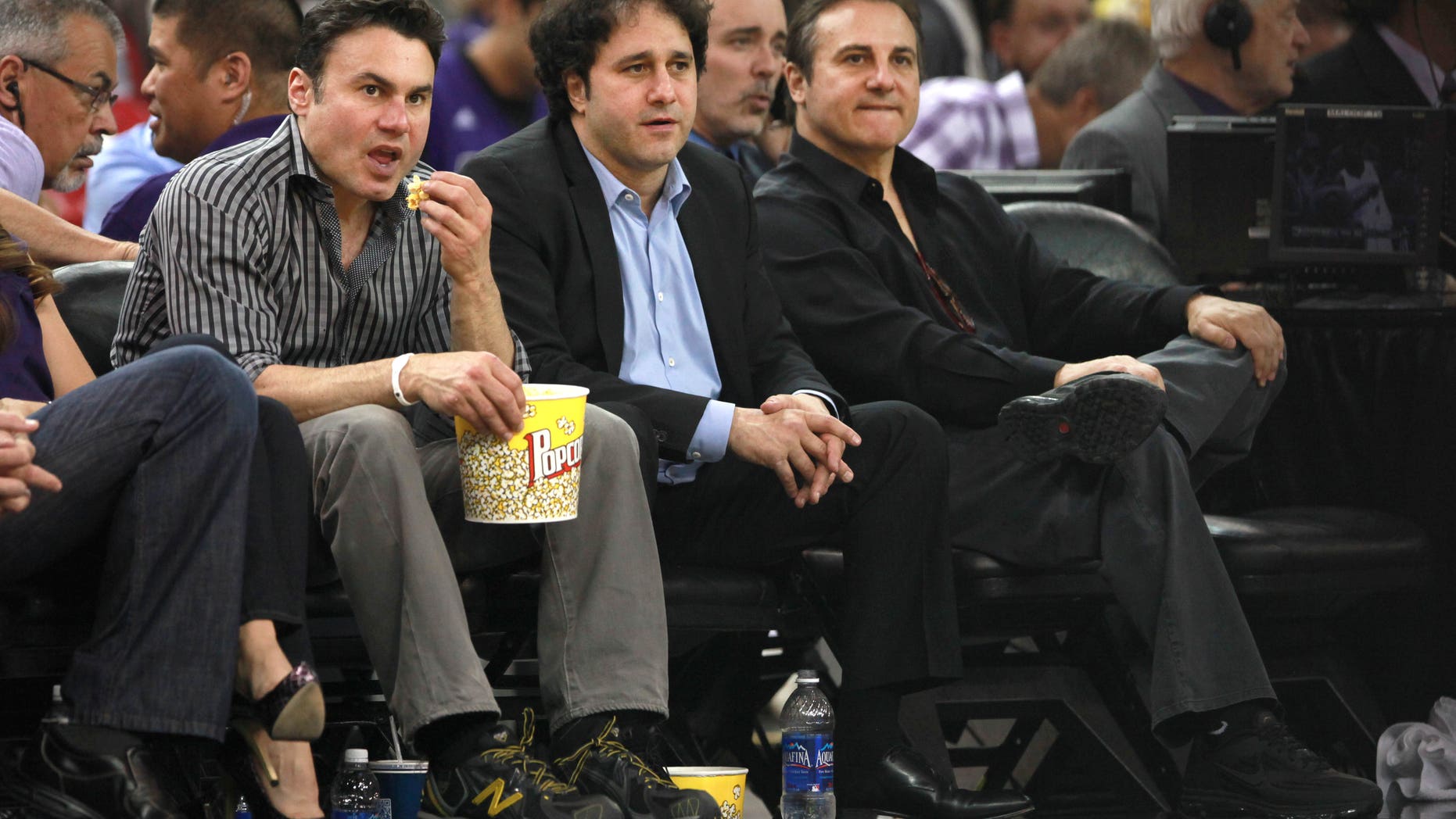 FILE - In this April 26, 2012 file photo, the Maloof brothers, Phil, left, George, center and Gavin, co-owners of the Sacramento Kings, watch their team against the Los Angeles Lakers during an NBA basketball game in Sacramento, Calif. The only thing stopping the Kings from a sale and move to Seattle is approval by NBA owners.The Maloof family has agreed to sell the Kings to a Seattle group led by investor Chris Hansen, the league confirmed in a statement Monday morning, Jan. 21, 2013.. The deal is still pending a vote by the NBA Board of Governors. (AP Photo/Rich Pedroncelli, FILe)