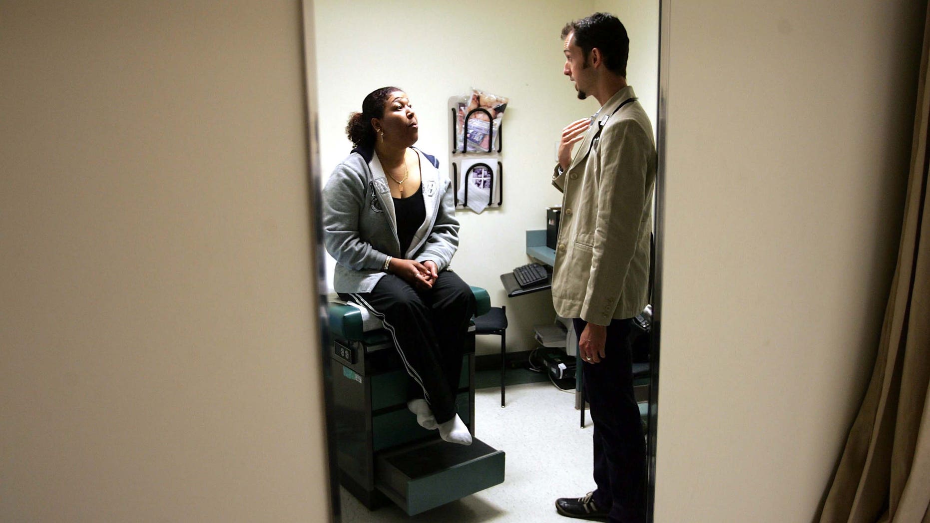 DORCHESTER, MA - APRIL 11: Dr. Ethan Brackett listens during an examination of patient Cristina Valdez at the Codman Square Health Center April 11, 2006 in Dorchester, Massachusetts. Governor Mitt Romney of Massachusetts is scheduled to sign a health care reform bill April 12 that would make this the first state in the nation to require all its citizens have some form of health insurance. (Photo by Joe Raedle/Getty Images)
