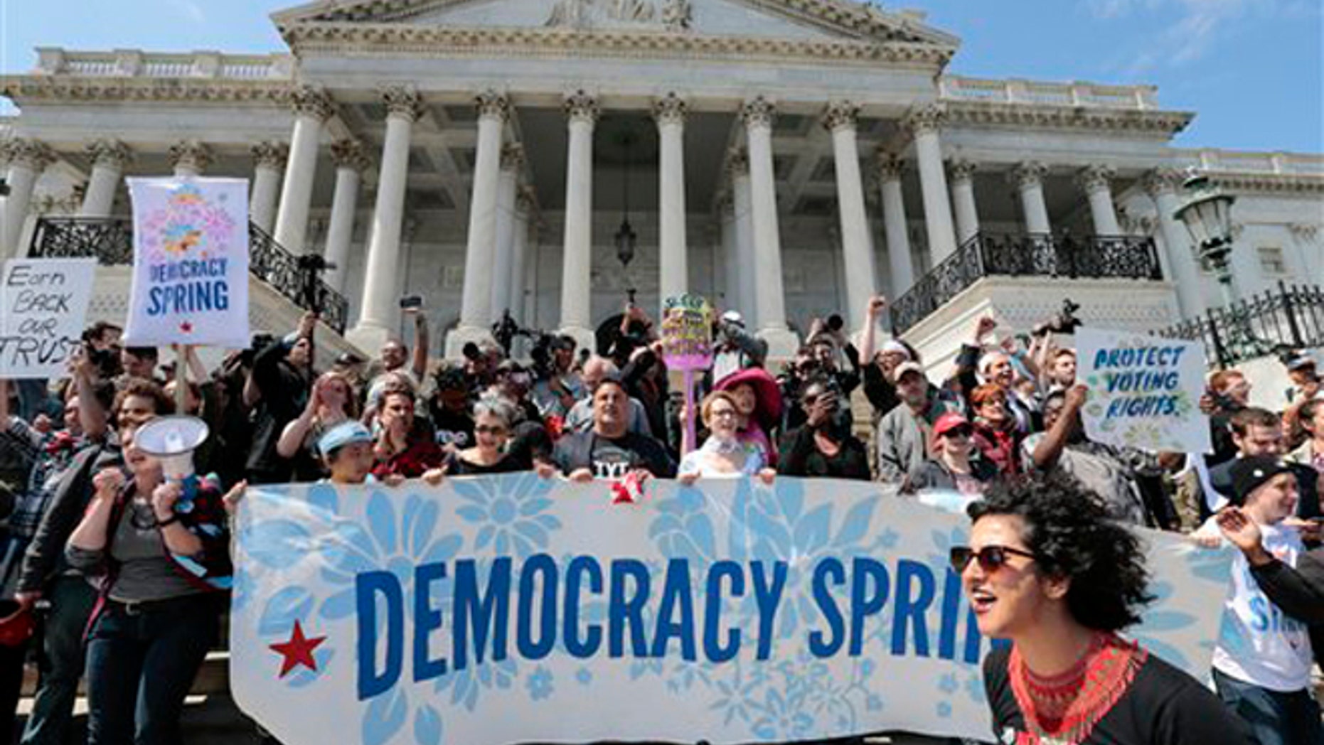 Alejandra Pablos of Arizona, lower right, leads a chant as voting rights reform demonstrators stage a sit-in at the Capitol in Washington, Monday, April 11, 2016, urging lawmakers to take money out of the political process. (AP Photo/J. Scott Applewhite)