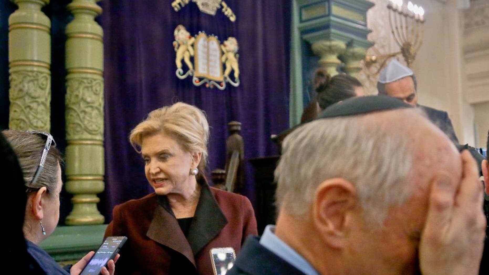 FILE - In this March 3, 2017, file photo, Congresswoman Carolyn Maloney, center, a member of Congress's bipartisan task force combating anti-Semitism, speaks with a reporter after holding a news conference to address bomb treats against Jewish organizations and vandalism at Jewish cemeteries at the Park East Synagogue in New York. Kendall Sullivan, a Connecticut man who posted threats against Jews and synagogues on a metal music internet forum plans to argue at his sentencing that he has served enough time in prison. Sullivan is scheduled to go before a U.S. District judge in Bridgeport on Monday, April 17. He pleaded guilty in January to perpetrating a hoax and originally faced three federal charges of making online threats. (AP Photo/Bebeto Matthews, File)