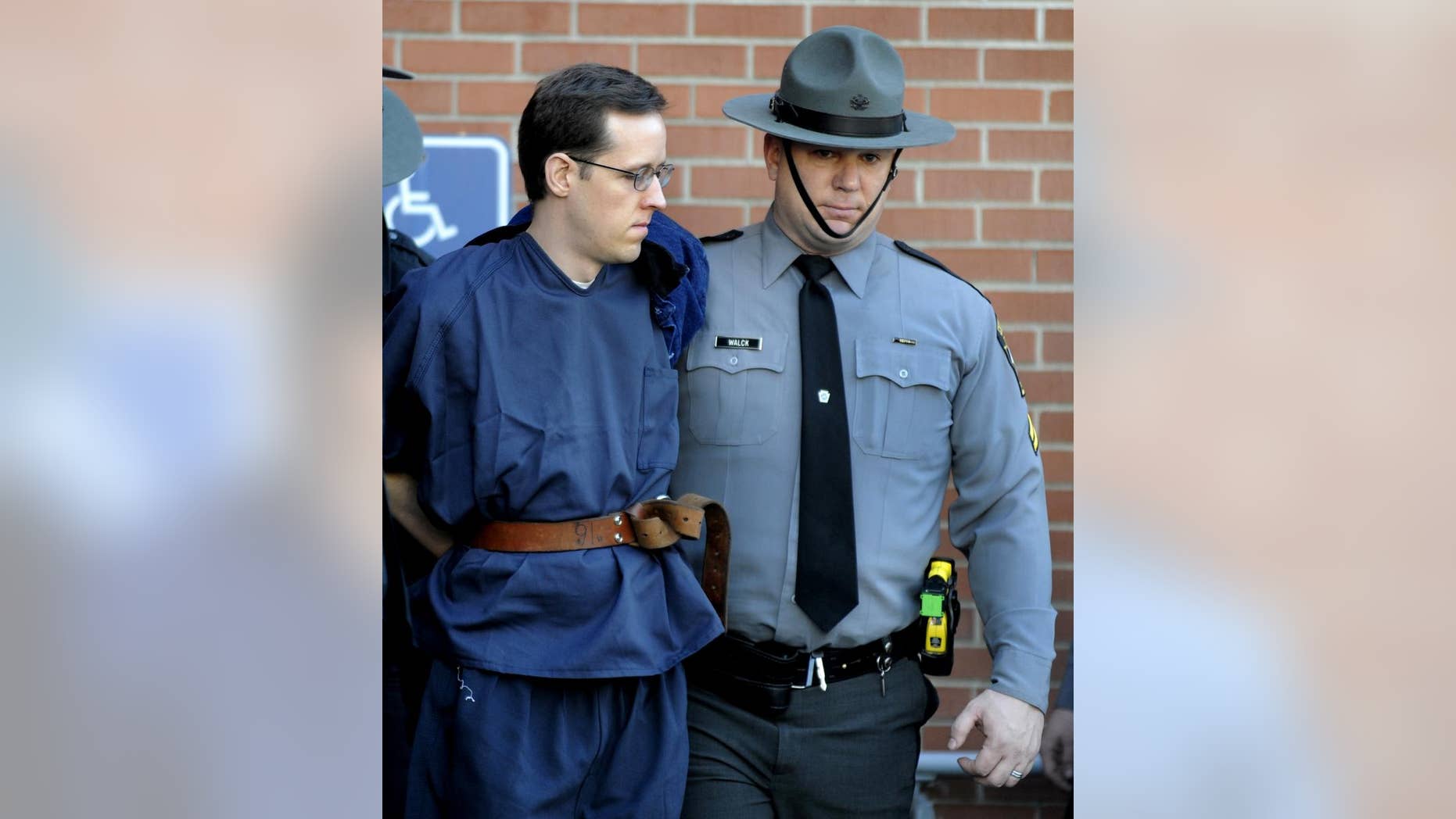 FILE- In this Jan. 5, 2015, file photo, Eric Frein, left, is led from the Pike County Courthouse after his preliminary hearing in Milford, Pa. Frein is charged with fatally shooting a Pennsylvania state trooper and wounded another during an ambush at their barracks in September. A formal arraignment for Frein is scheduled for Thursday, Jan. 29, 2015, at the courthouse in Milford. (AP Photo/David Kidwell, File)