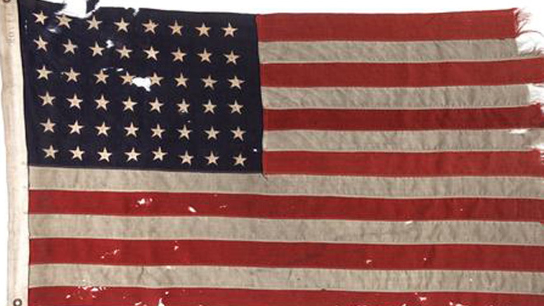 This undated photo provided by Heritage Auctions shows a U.S. flag flown on the stern of the boat that led the first American troops onto Utah Beach on D-Day.