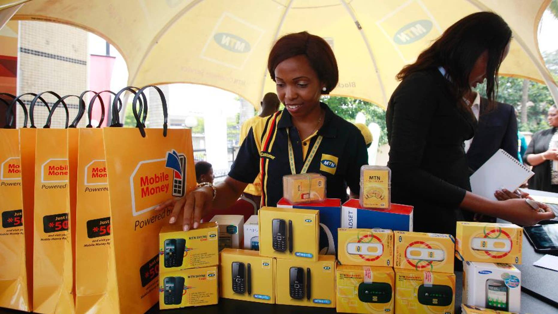 FILE- In this Monday April. 22, 2013 file photo, staff of MTN Nigeria workduring the launch of mobile number portability in Lagos, Nigeria. MTN Group telecommunication’s stock plunged 12.5 percent on the Johannesburg Stock Exchange Monday, Oct. 26, 2015 on the news that its most lucrative subsidiary, in Nigeria, has been fined $5.2 billion for failing to disconnect millions of unregistered cellphone subscribers.The Nigerian Communications Commission confirmed the penalty based on 200,000 naira ($1,000) for each of 5.1 million cellphone SIM cards that had not been registered and should have been disconnected by an August deadline. (AP Photo/Sunday Alamba file)